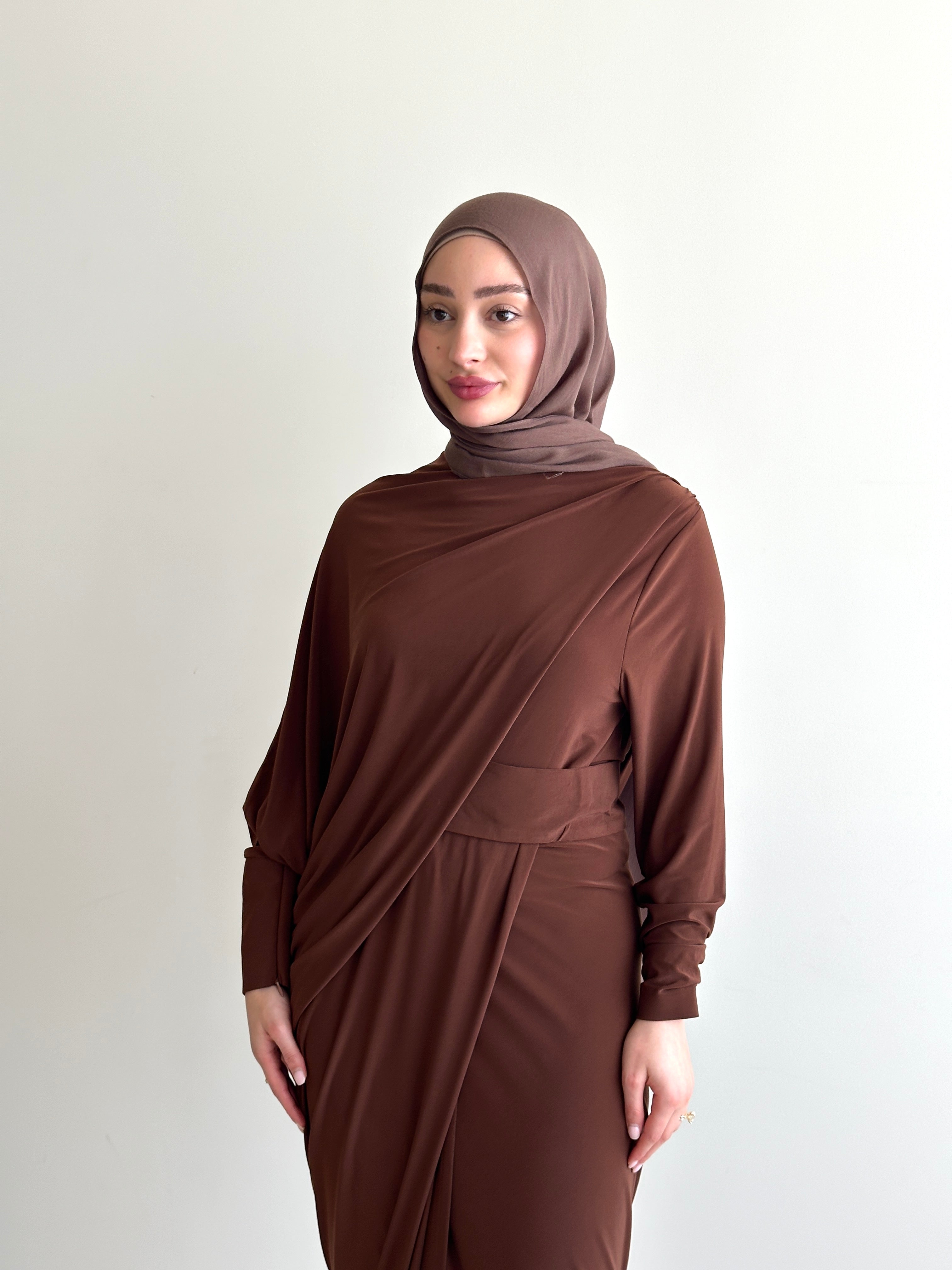 Crafted from a soft, breathable jersey fabric, this dress drapes beautifully over the silhouette while offering stretch and movement that feels as comfortable as it looks.