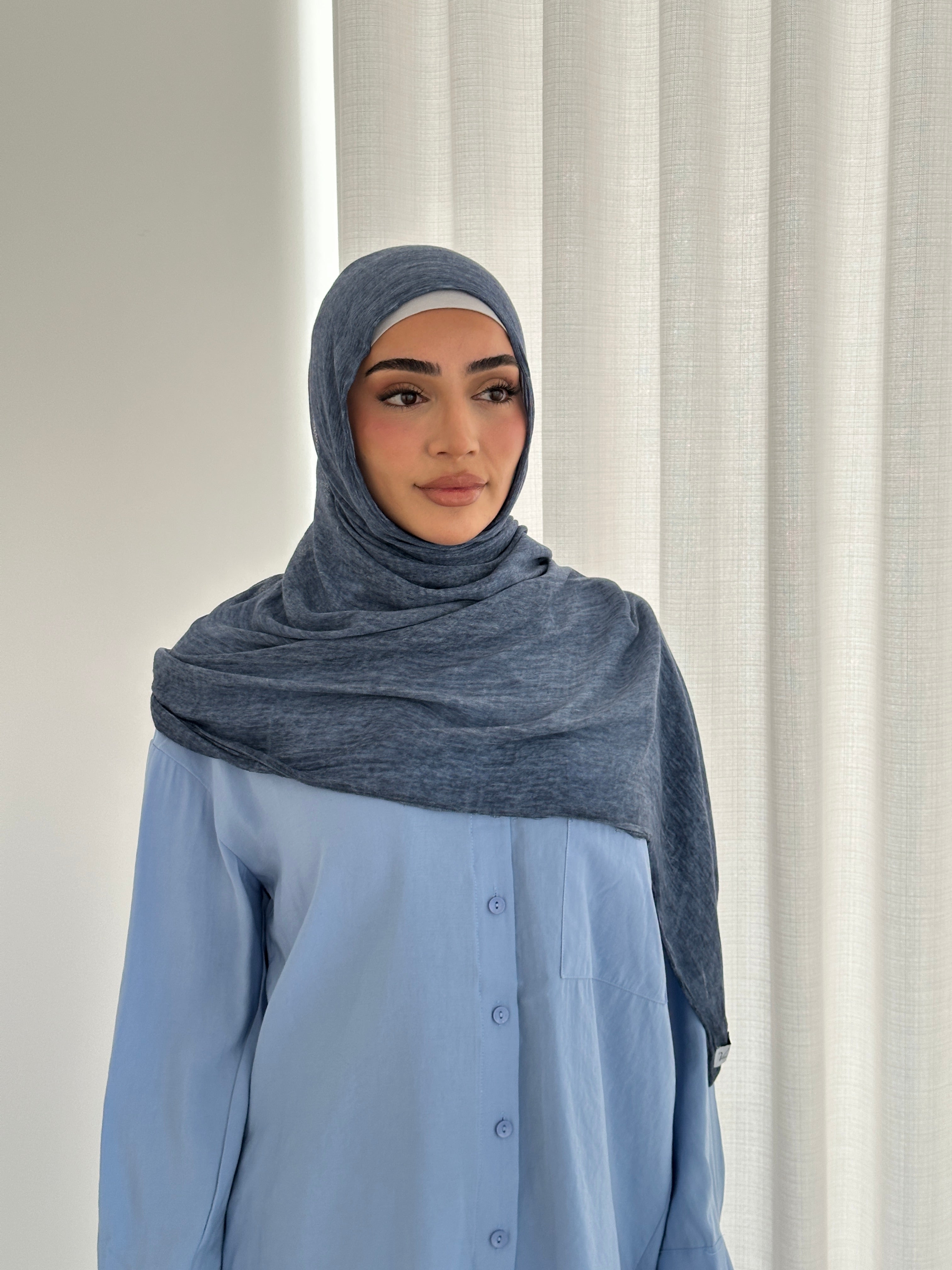 Crafted from soft rayon, this textured hijab drapes effortlessly while offering a breathable and lightweight feel.