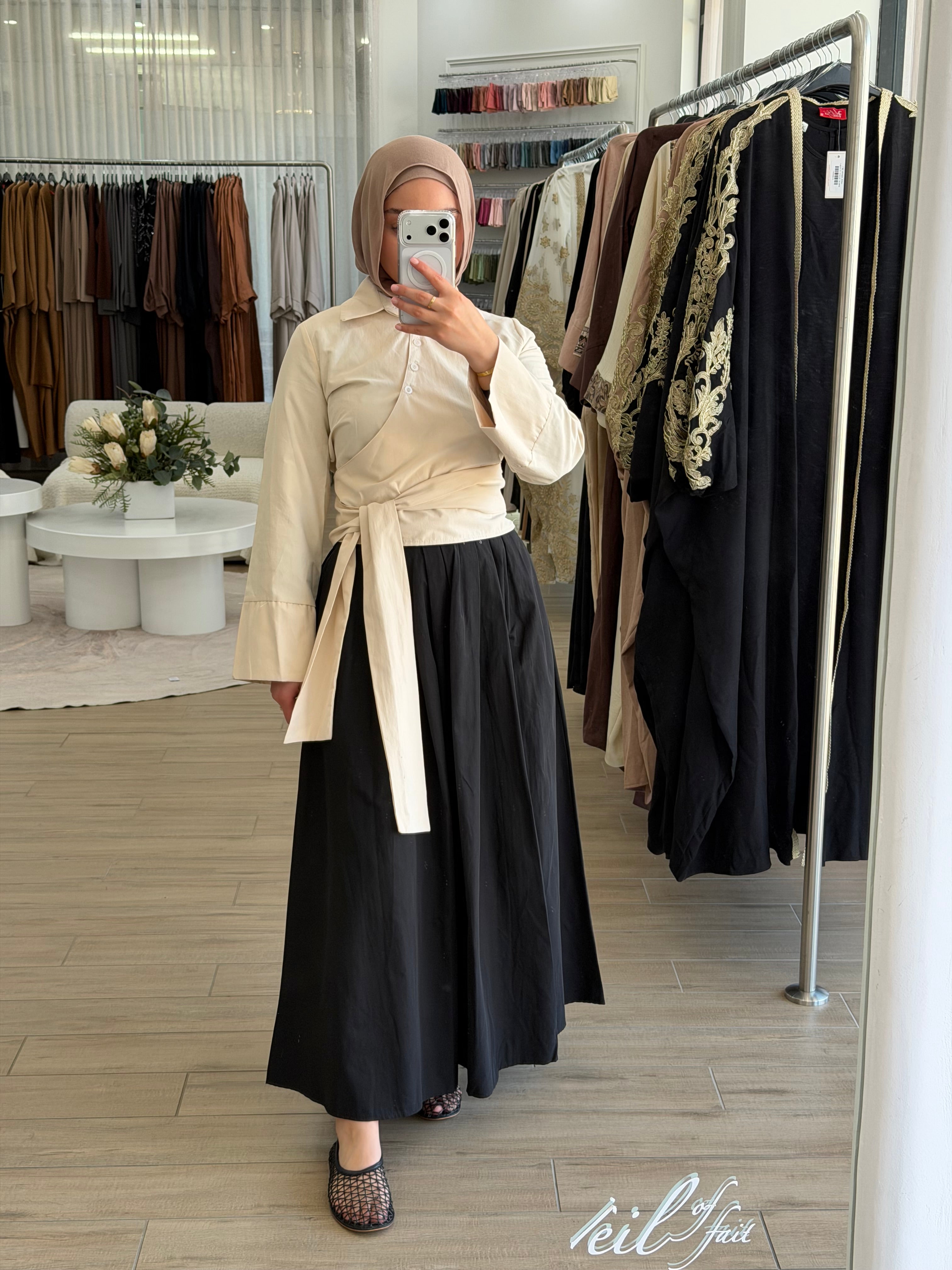 Woman wearing the Amara flow skirt, featuring a high-waisted fit and fluid, modest silhouette.