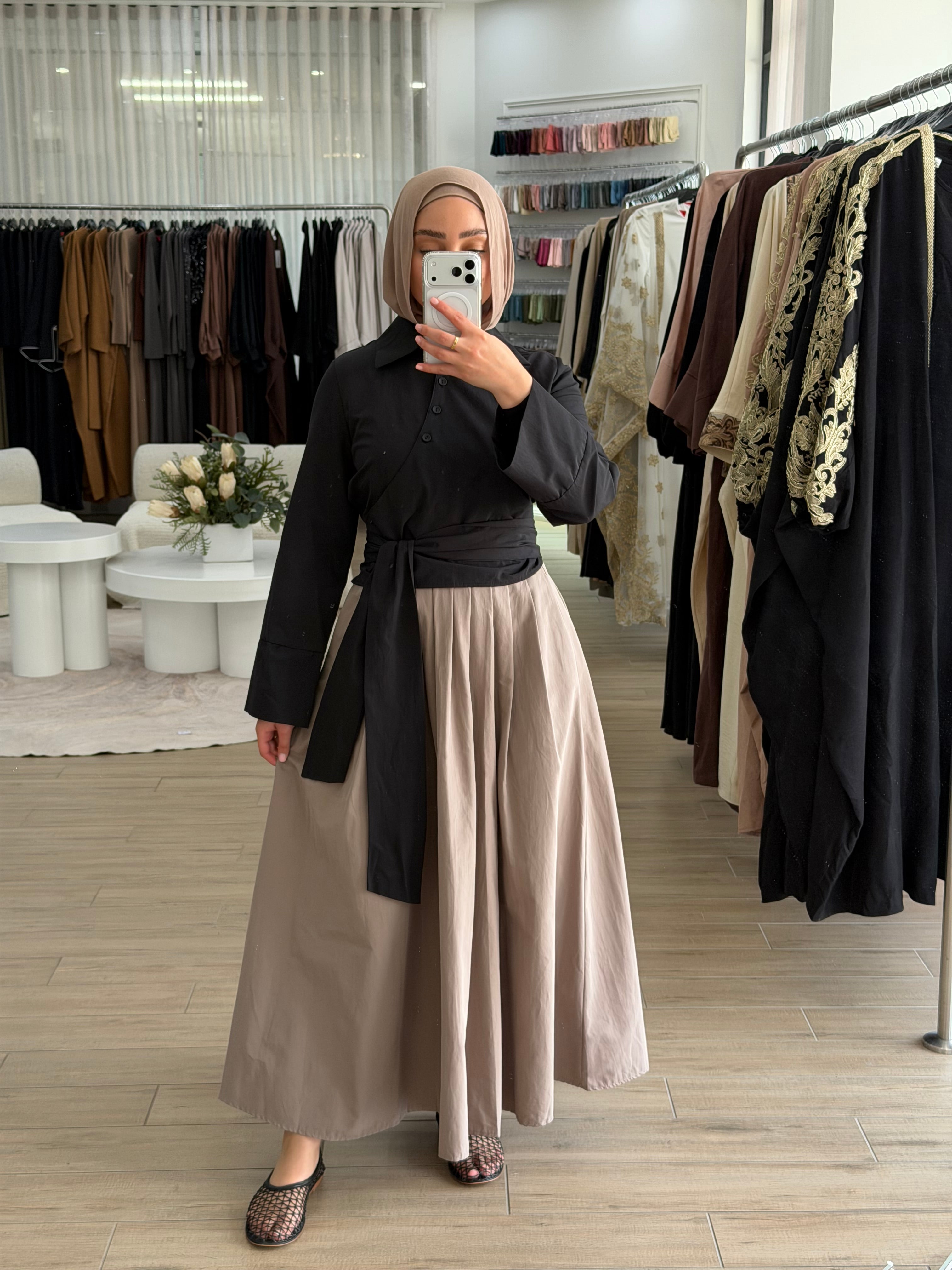 Woman wearing the Amara flow skirt, featuring a high-waisted fit and fluid, modest silhouette.