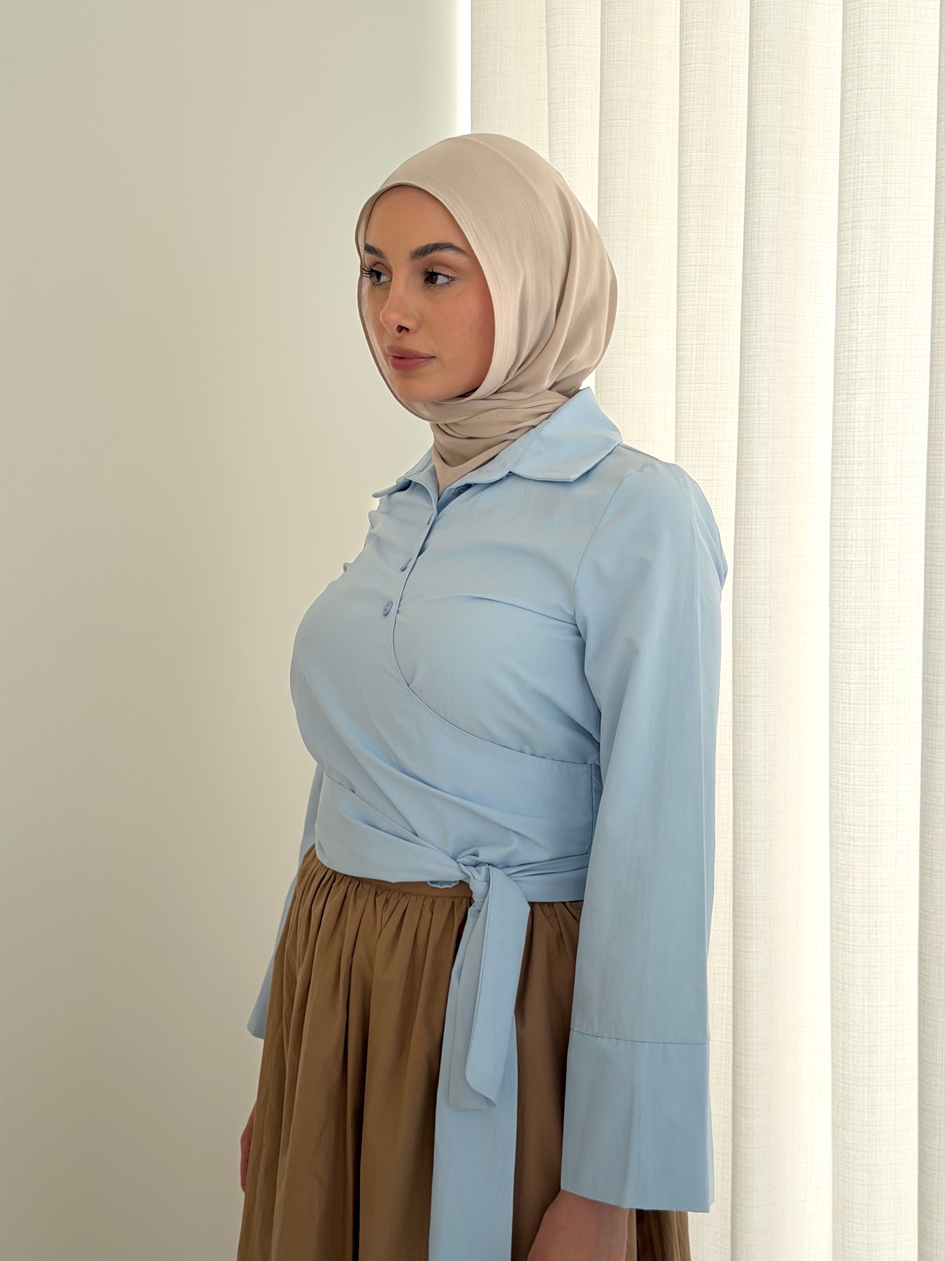 women's button wrap shirt with tie, collar and long sleeves in baby blue and white. top for hijabi friendly, modest fashion.