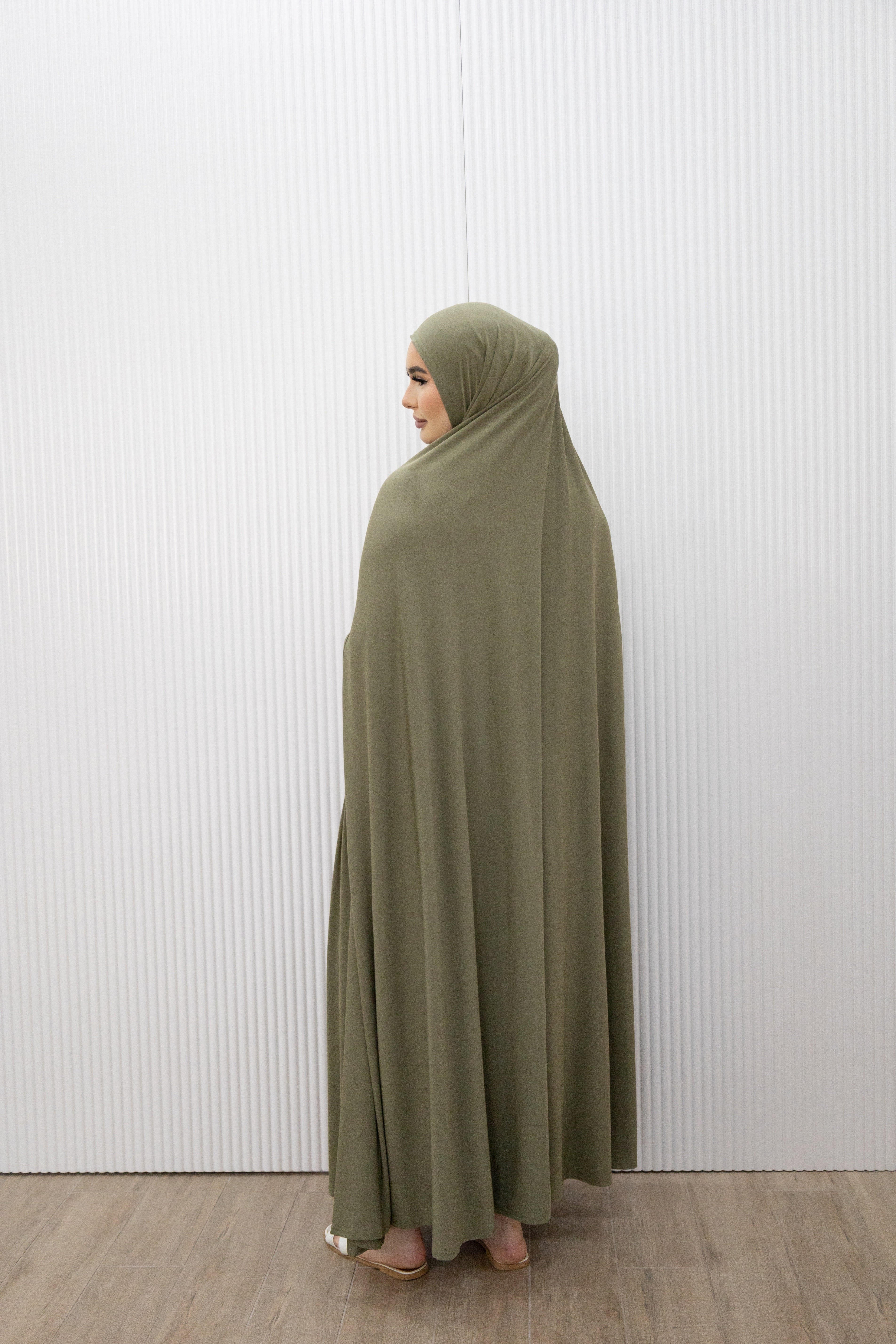 Model wearing a floor-length jilbab with a loose, flowing silhouette, styled for comfortable and modest everyday wear.