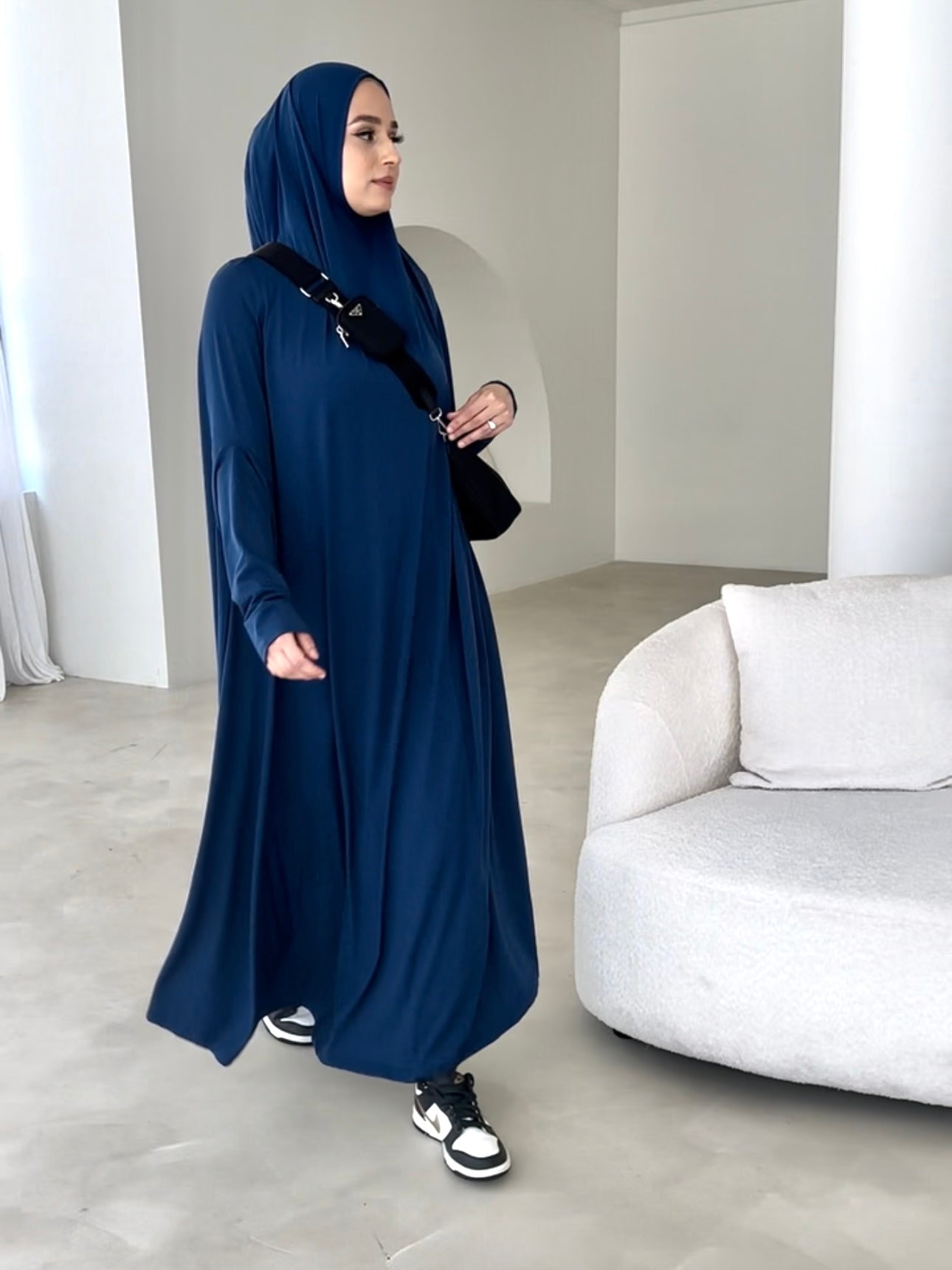 Model wearing a floor-length jilbab with a loose, flowing silhouette, styled for comfortable and modest everyday wear.