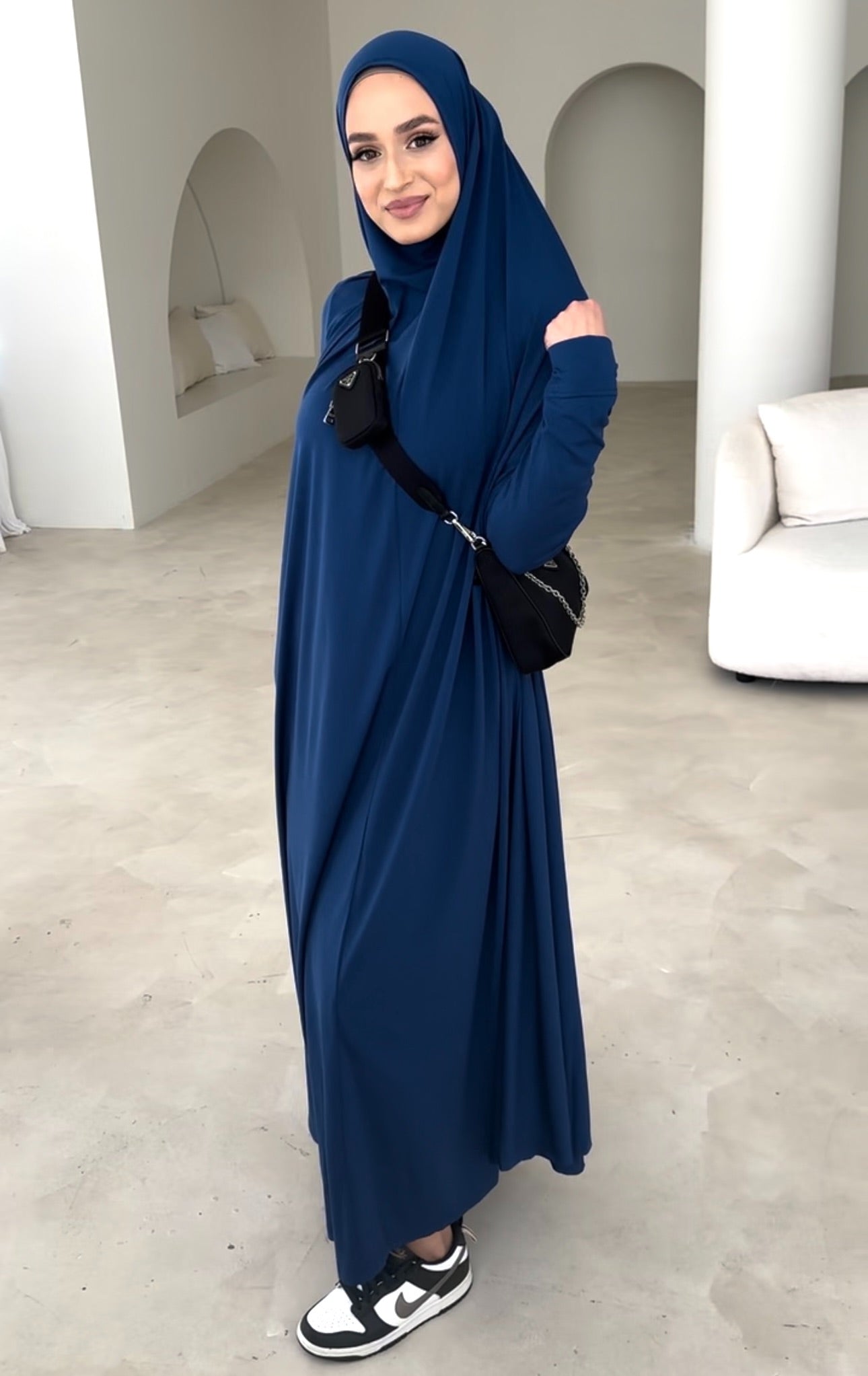 Model wearing a floor-length jilbab with a loose, flowing silhouette, styled for comfortable and modest everyday wear.