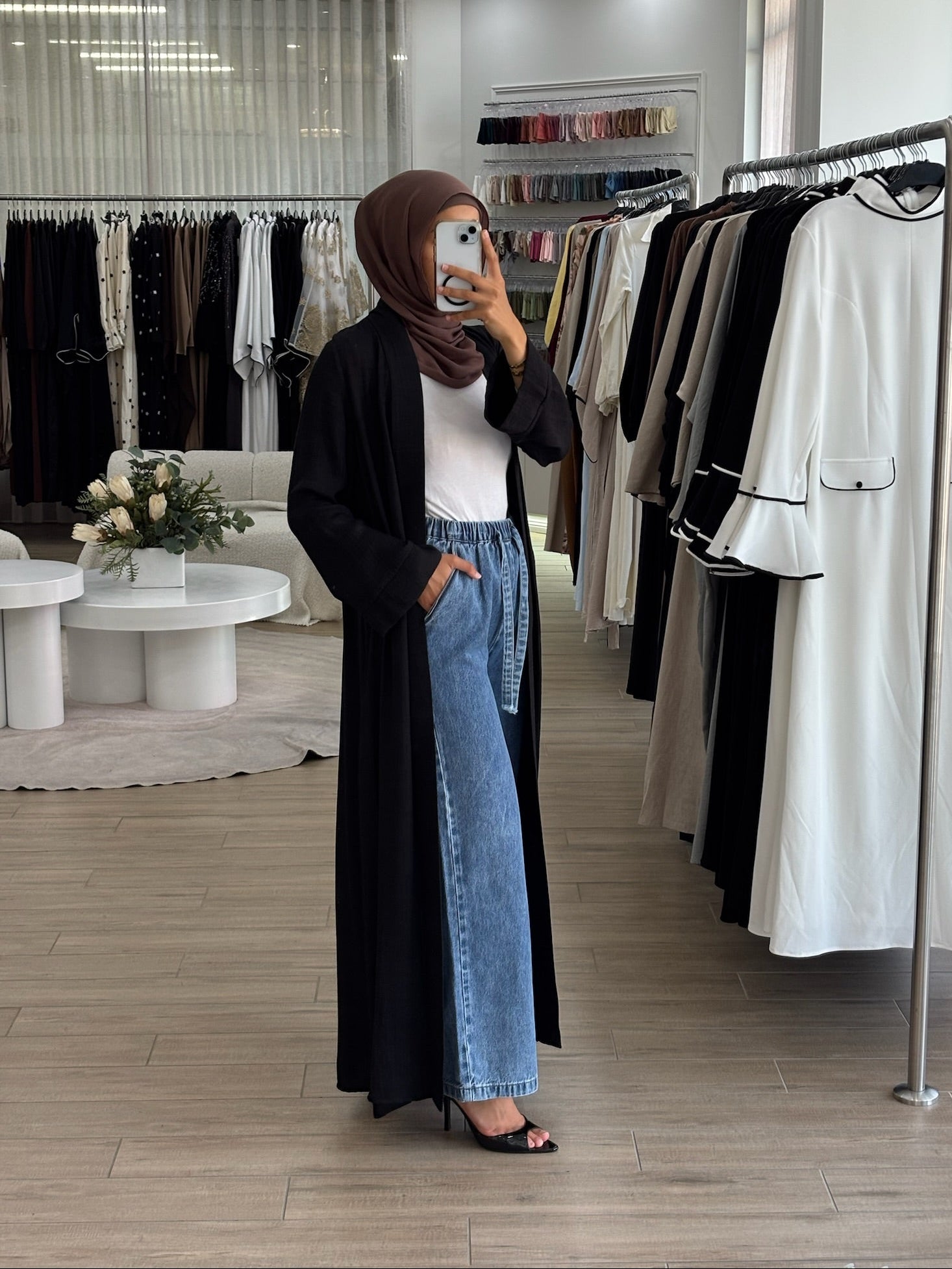 Side view of a long light kimono in black, showing its airy fabric and fluid drape.