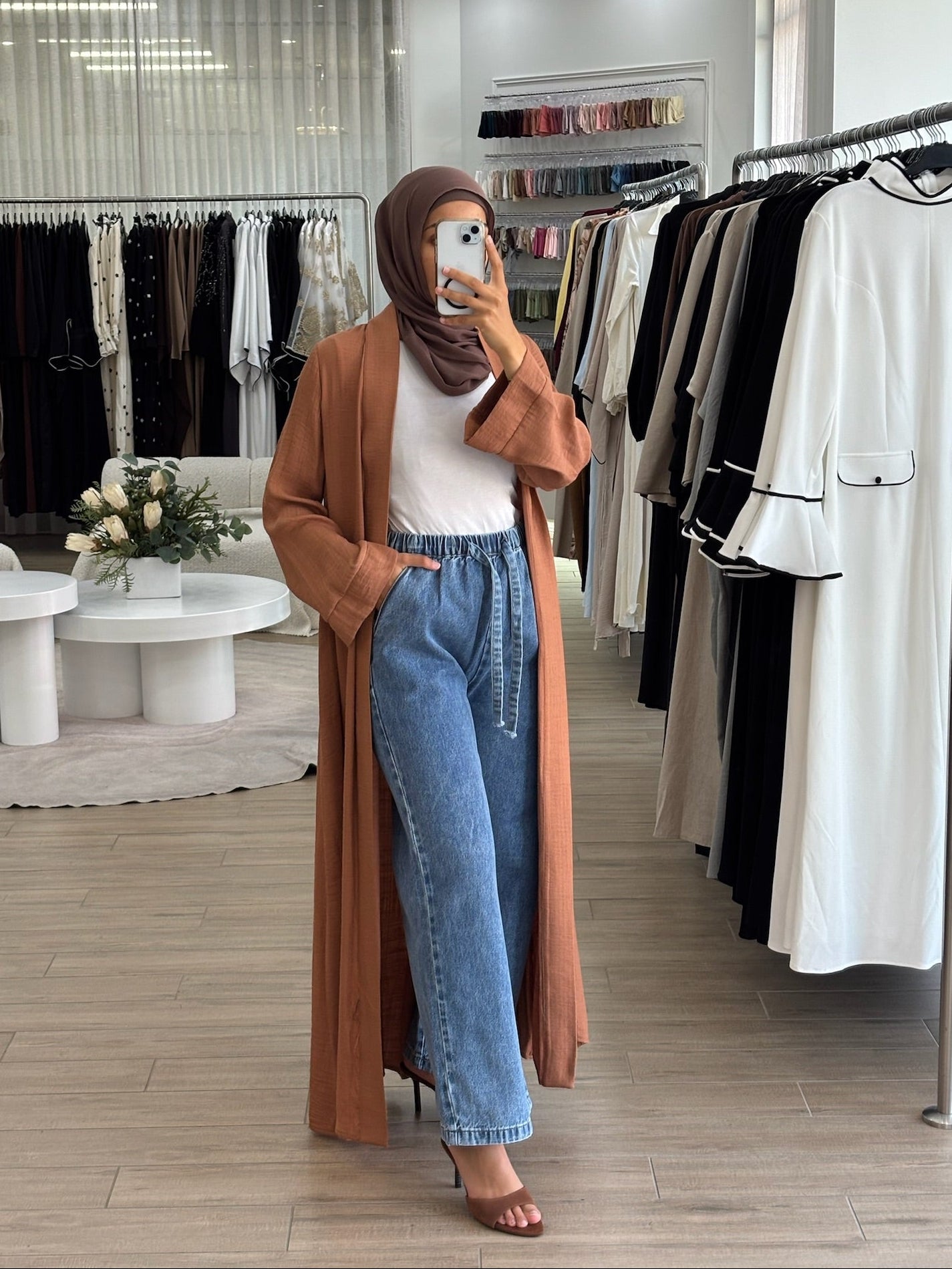 Side view of mid blue straight-flow denim pants with a loose wide-leg silhouette and modest, flowy fit.