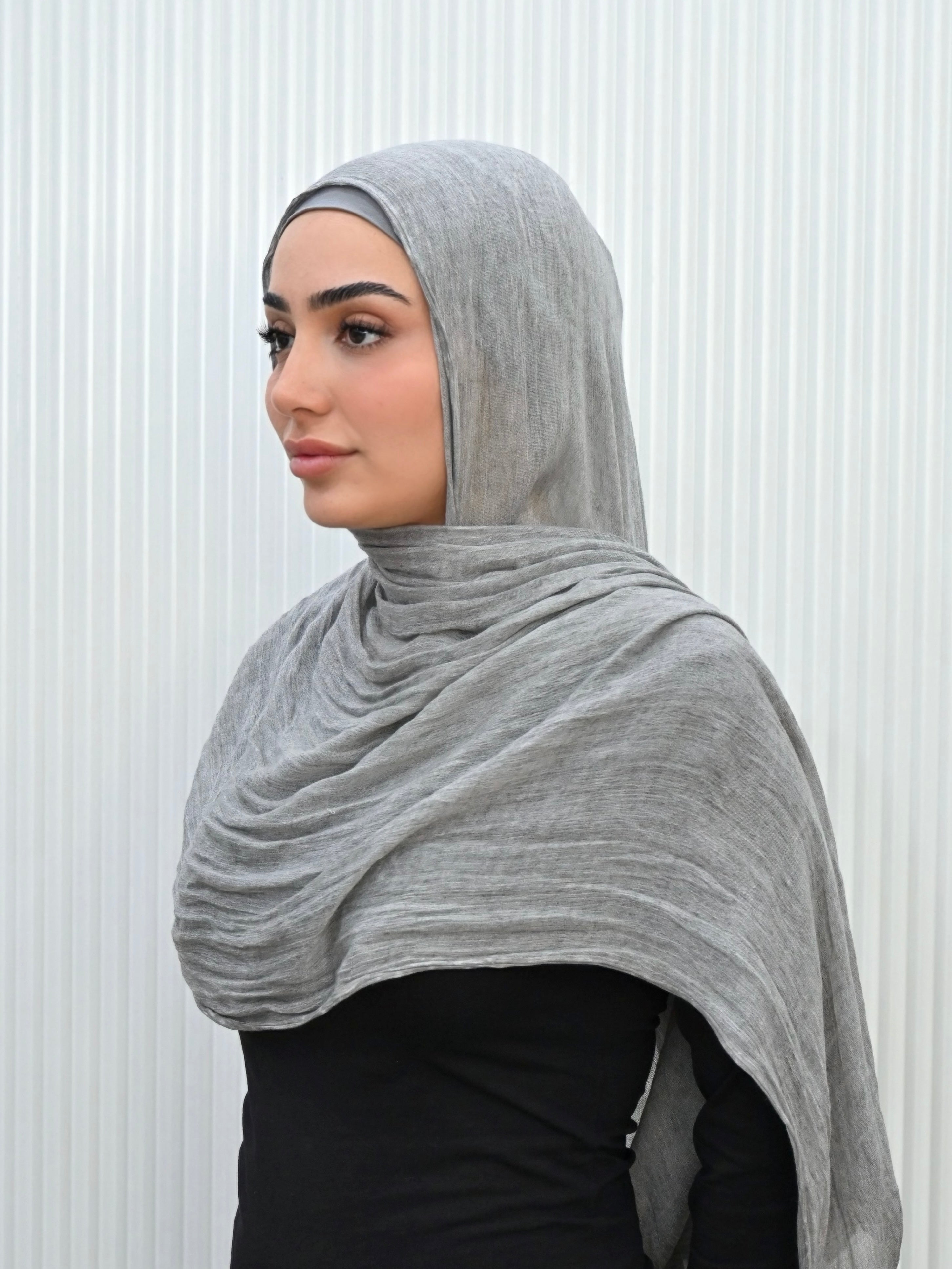 Crafted from soft rayon, this textured hijab drapes effortlessly while offering a breathable and lightweight feel. Its subtle texture adds depth and dimension, perfect for everyday wear.