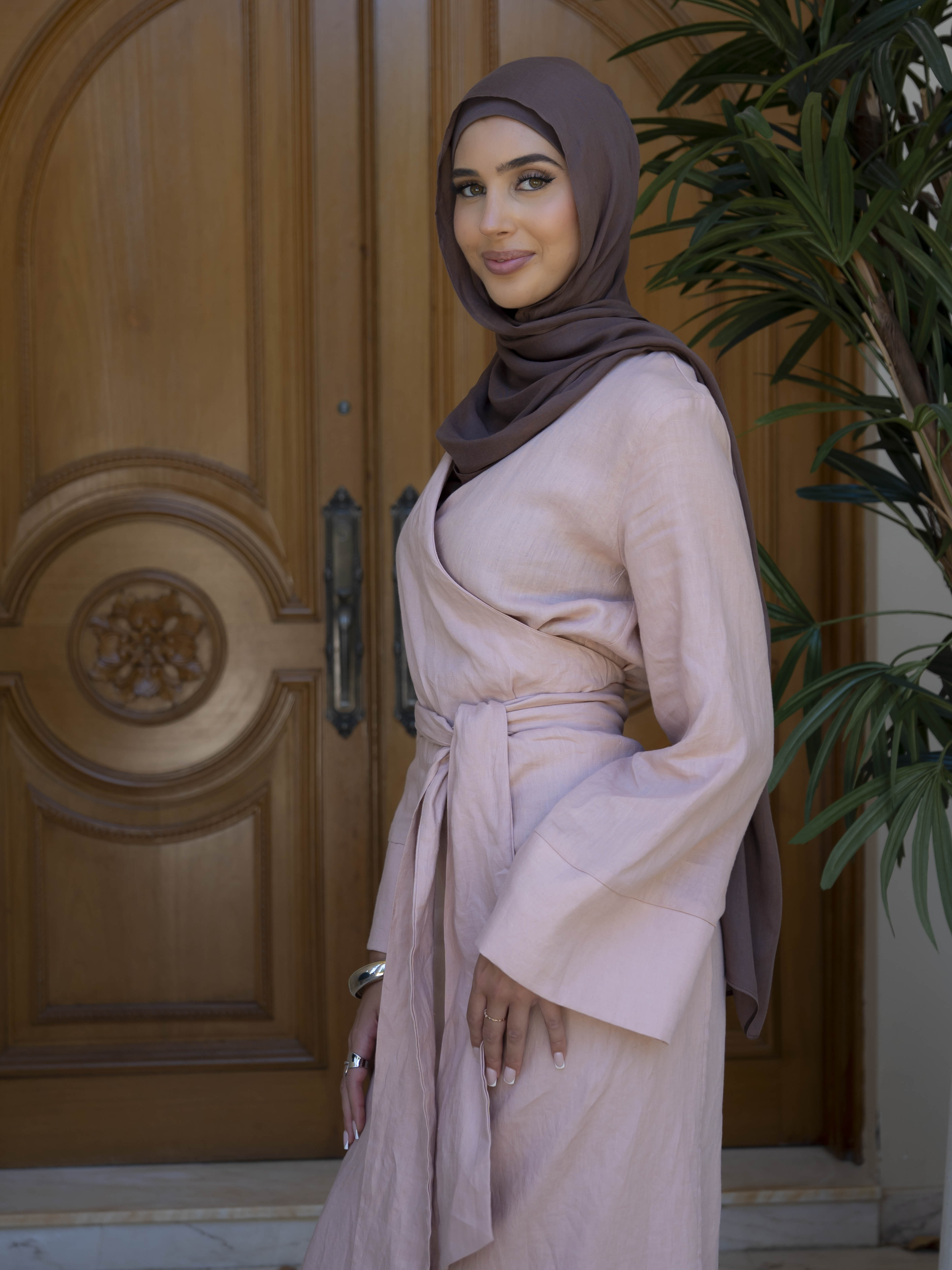 Model wearing the Linen Kimono Wrap featuring a relaxed silhouette in breathable linen fabric, styled as a wrap for a modest and effortless look.