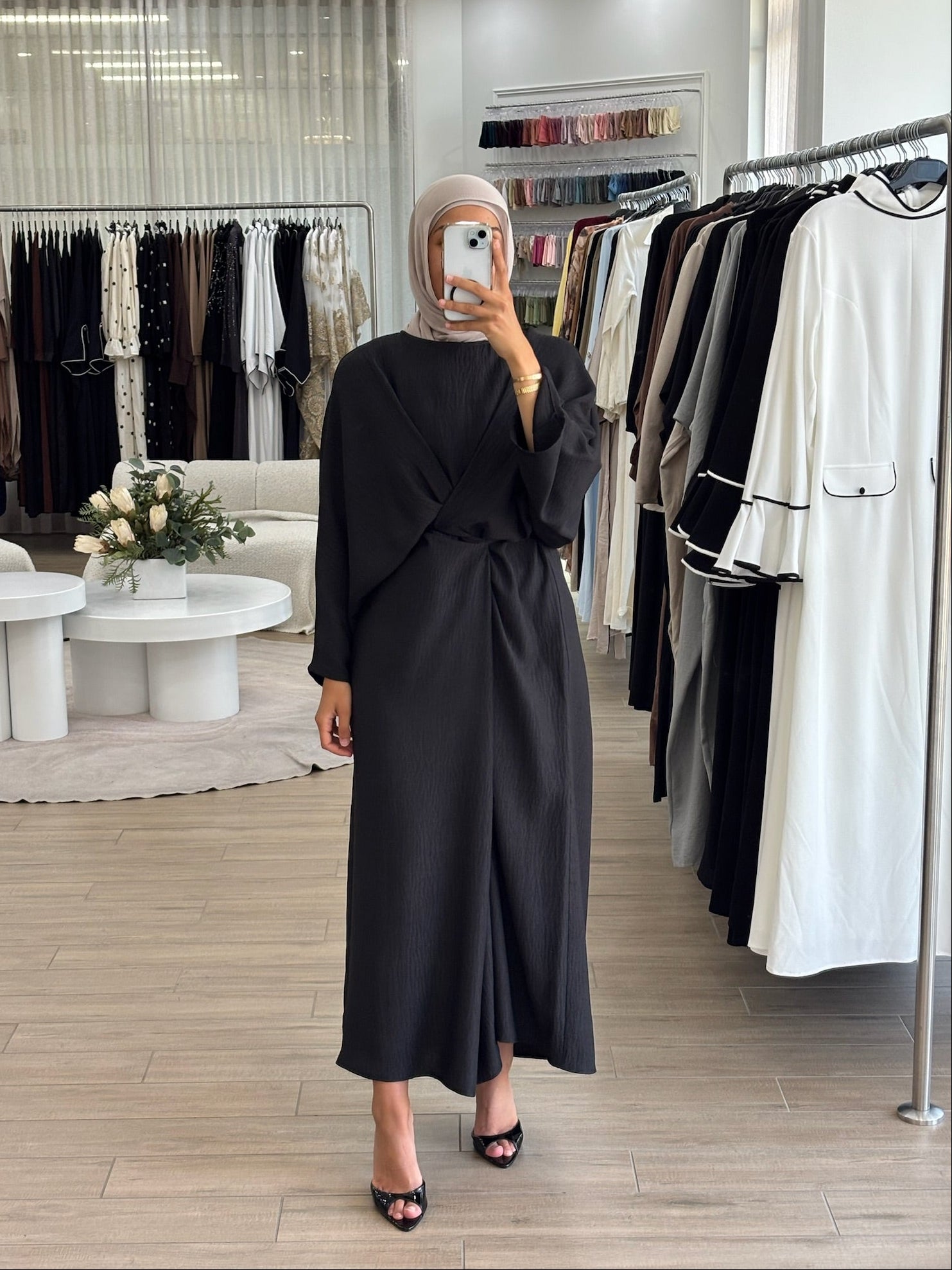 Woman wearing a long wrap two-way dress, featuring an adjustable wrap design and flowing modest silhouette.