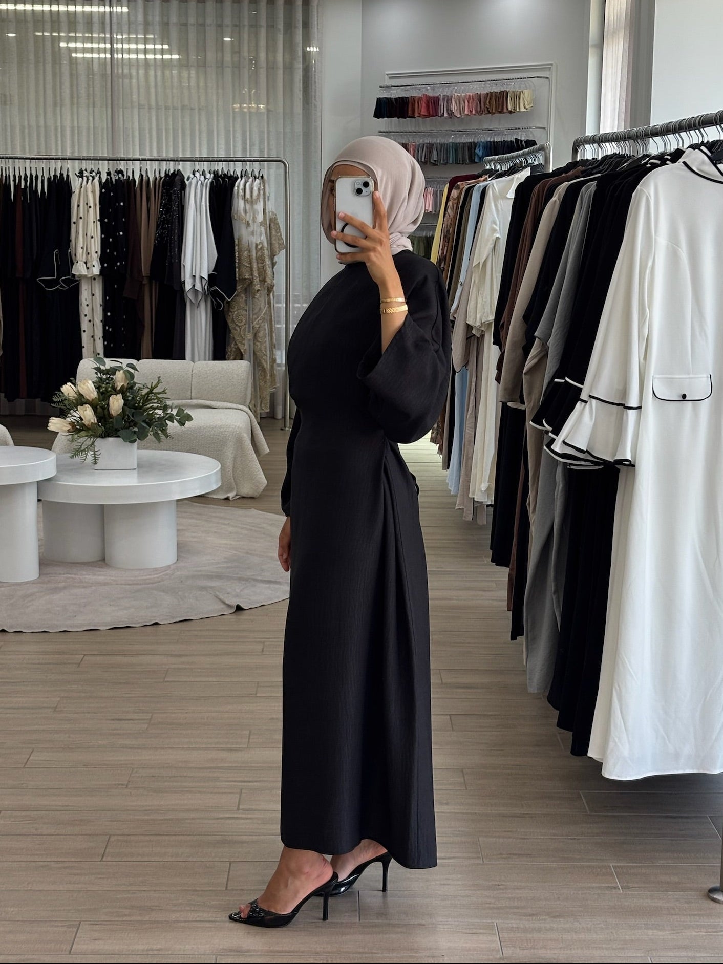 Side view of a long wrap dress with a fluid drape and elegant longline shape.