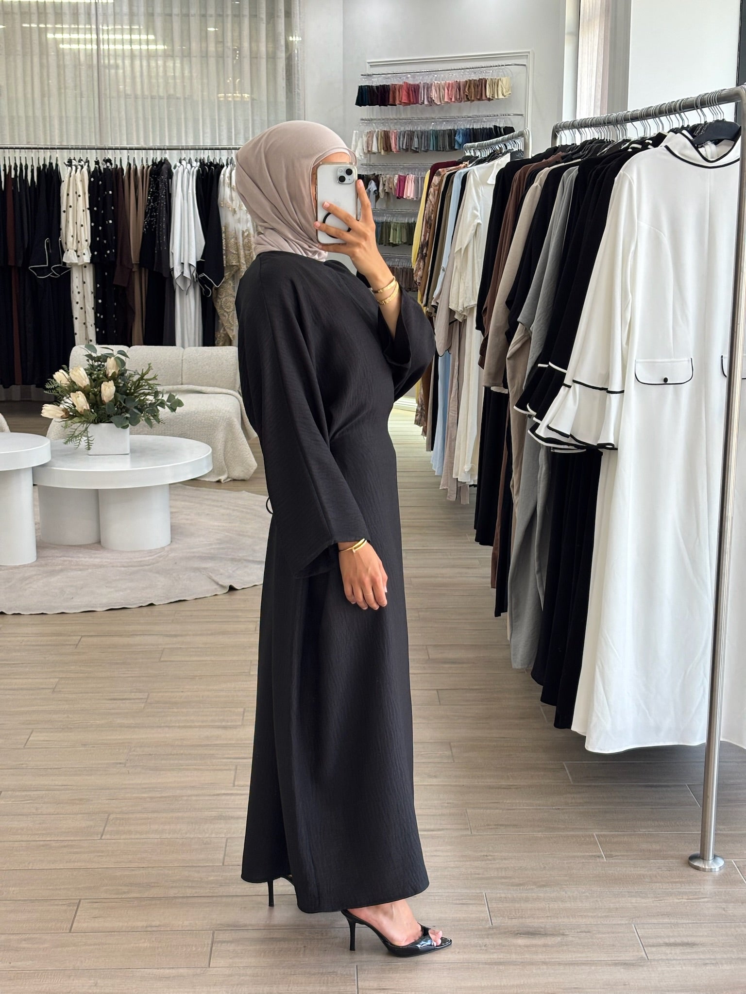 Side view of a long wrap dress with a fluid drape and elegant longline shape.