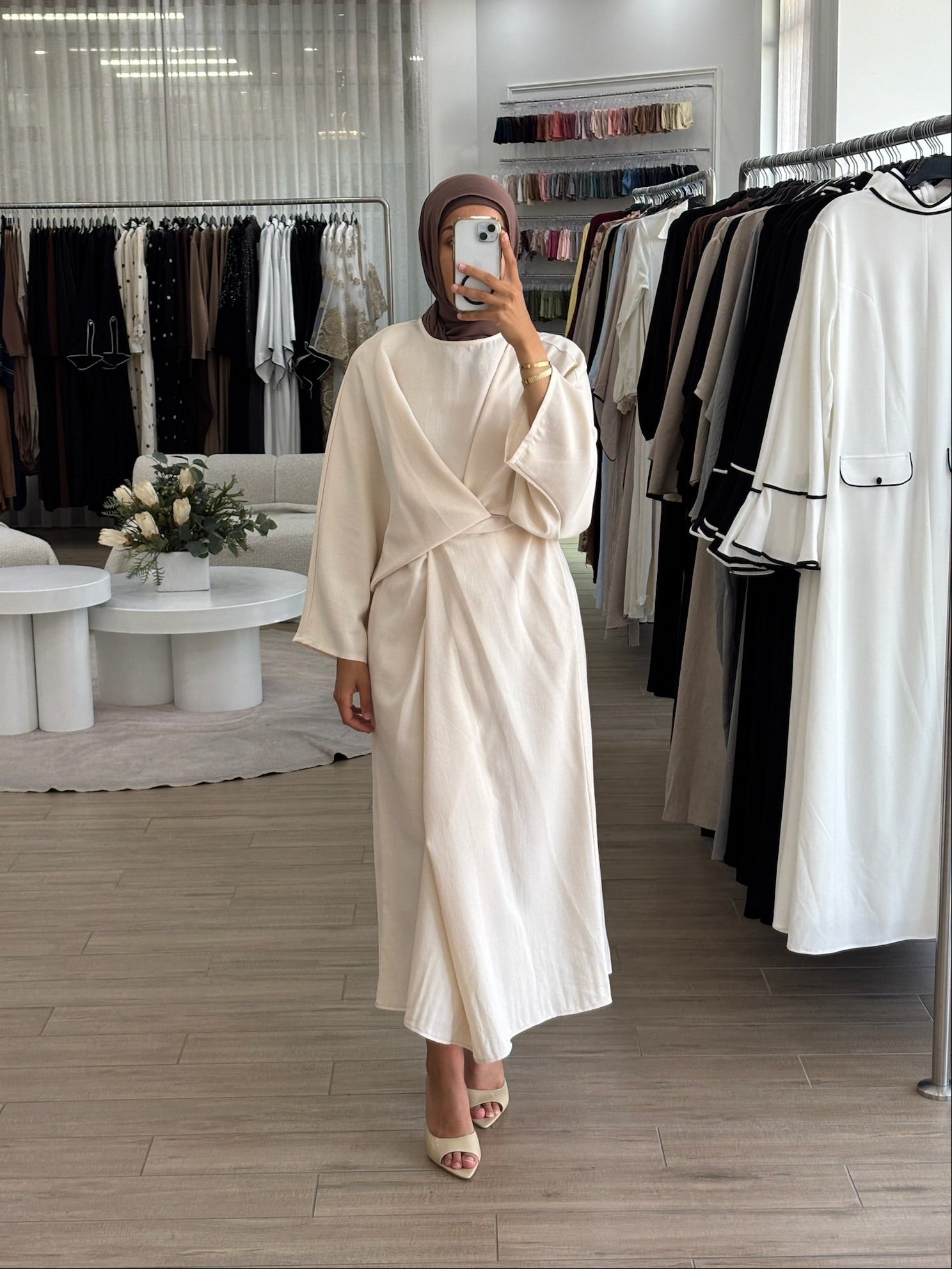 Woman wearing a long wrap two-way dress, featuring an adjustable wrap design and flowing modest silhouette.