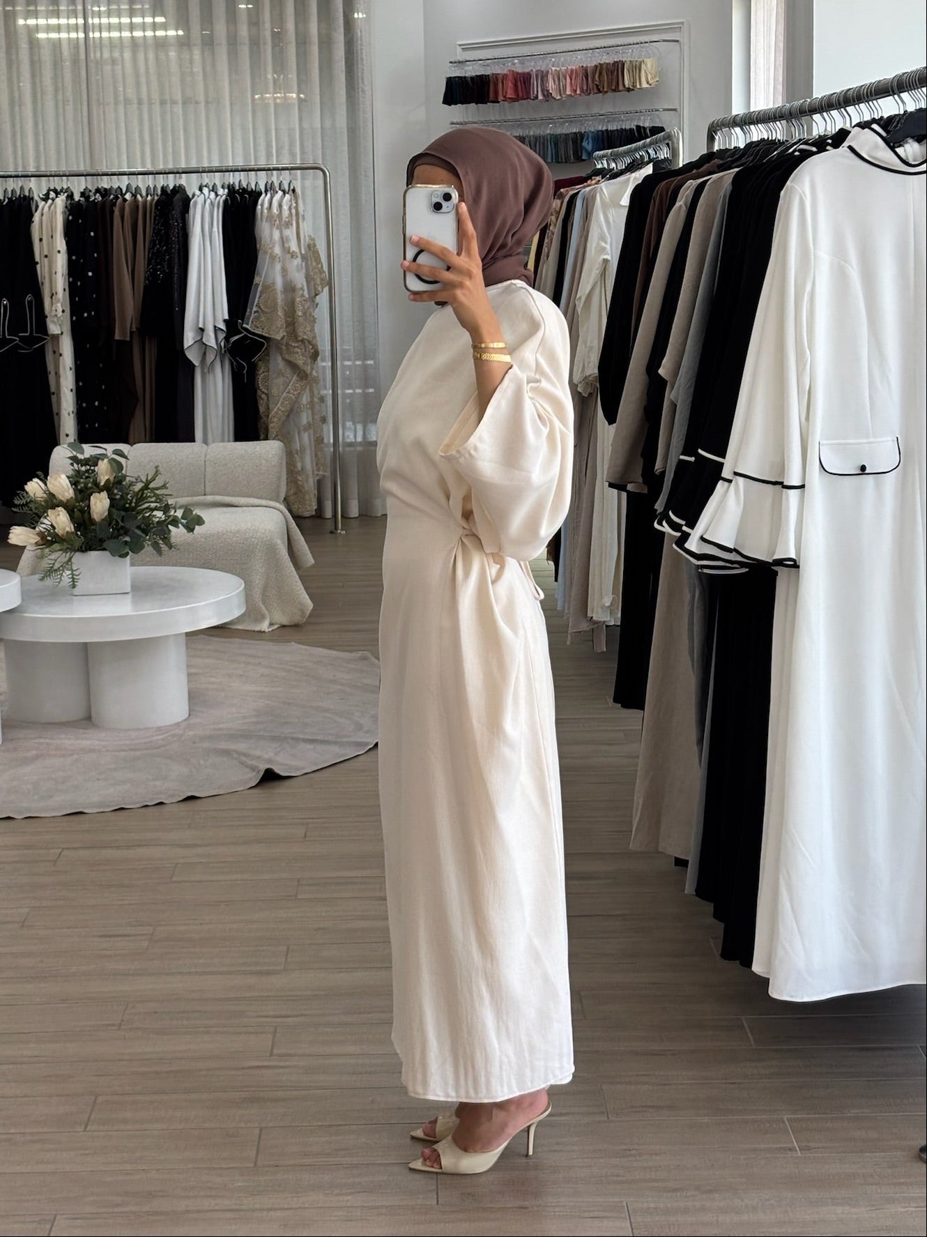 Side view of a long wrap dress with a fluid drape and elegant longline shape.