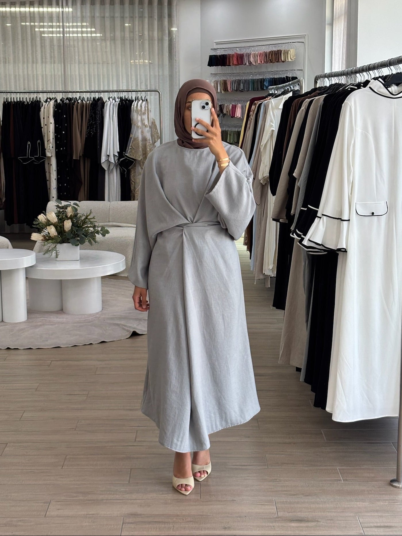 Woman wearing a long wrap two-way dress, featuring an adjustable wrap design and flowing modest silhouette.