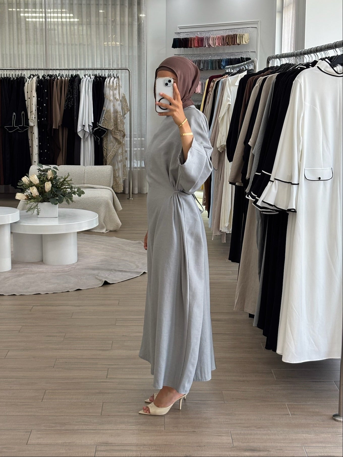 Side view of a long wrap dress with a fluid drape and elegant longline shape.