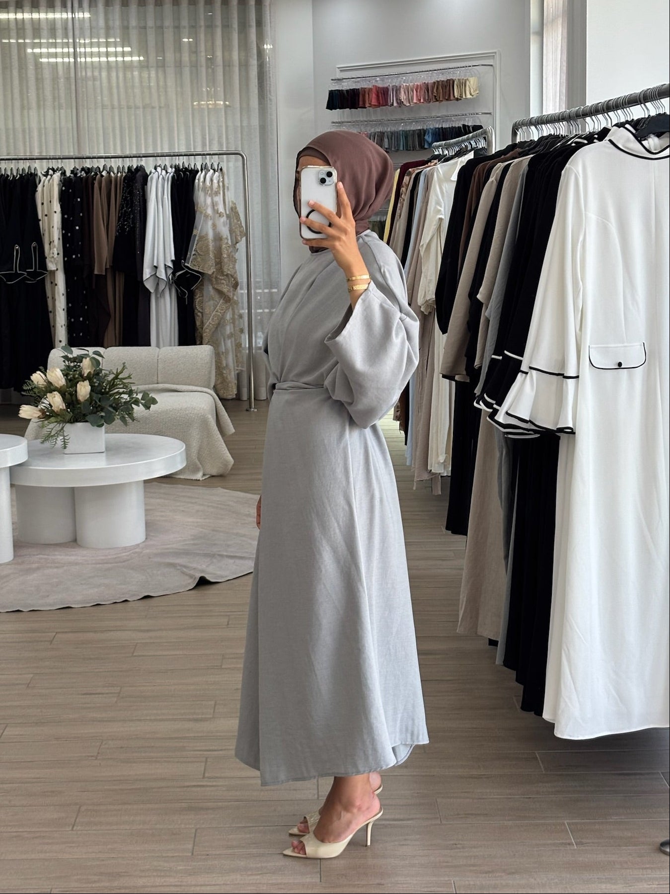 Side view of a long wrap dress with a fluid drape and elegant longline shape.