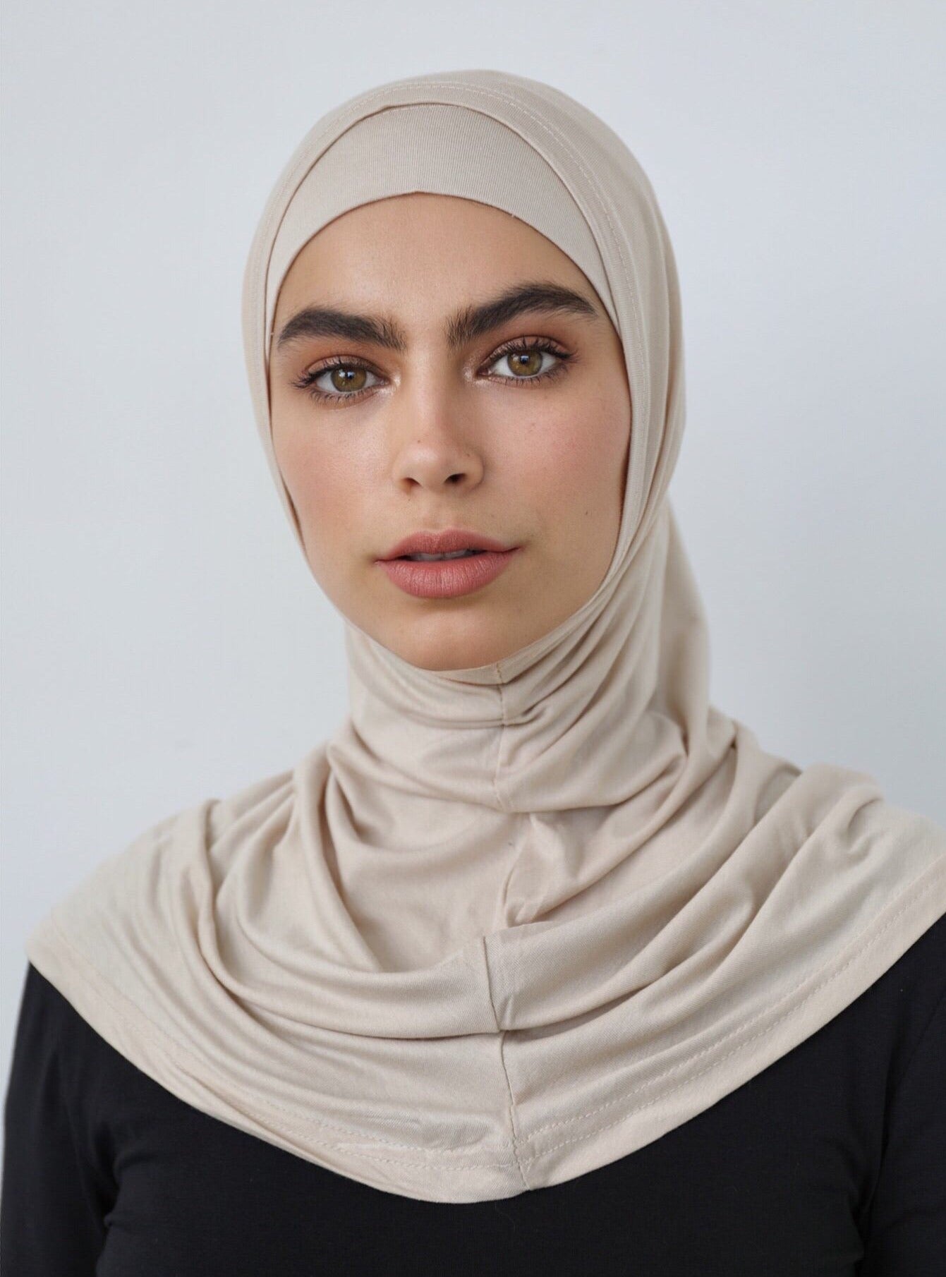 Our signature 2 piece scarf is made from a soft and stretchy, breathable cotton. It features a cap and overlay scarf that covers the head, neckline and skims over the shoulders. Wear it with your basics for an easy look. 
