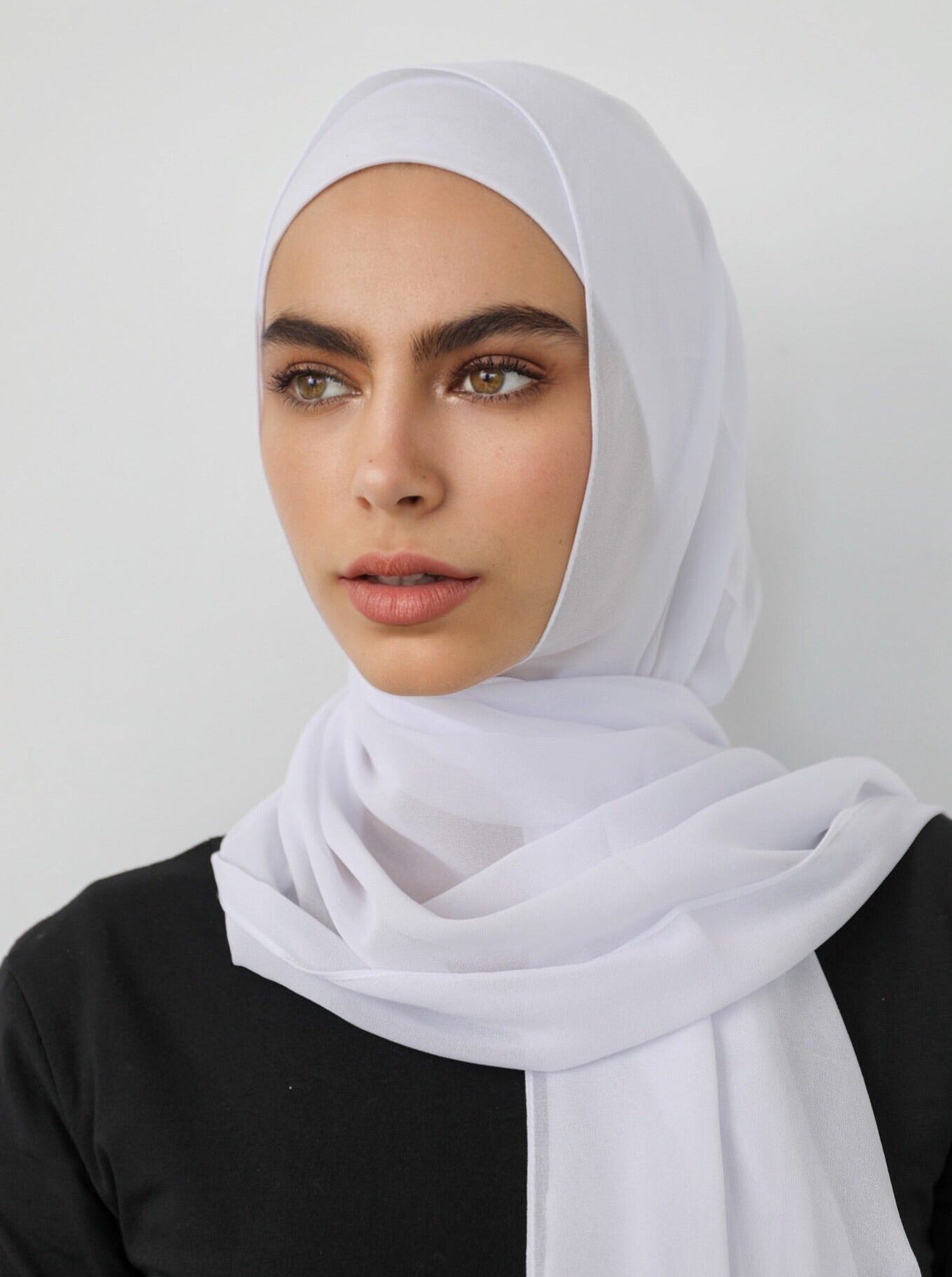Signature crepe hijab with a soft, flowy drape and slightly higher opacity than chiffon. Features a non-slip finish for secure, comfortable all-day wear. Suitable for everyday use and special occasions. Includes matching open cotton undercap.