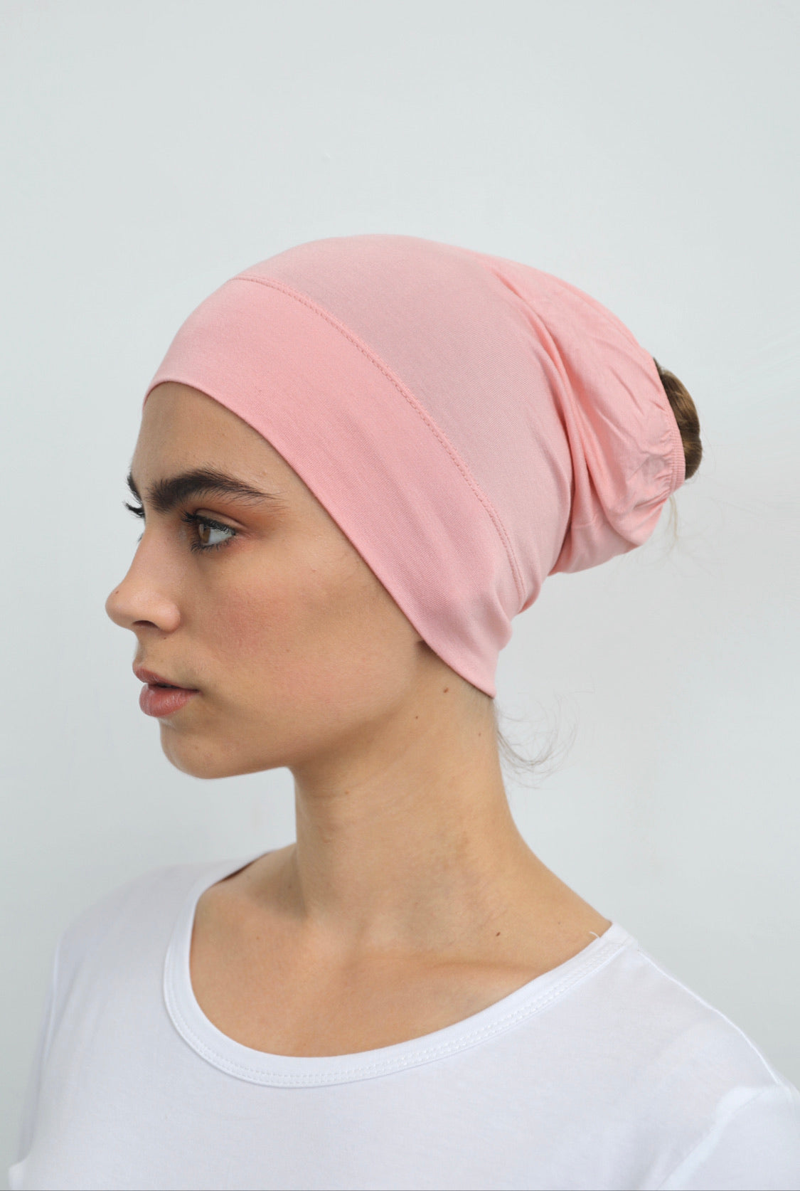 Bamboo under-scarf cap designed to cover hair beneath a hijab, made from soft, breathable natural bamboo fibers with cotton spandex stretch for comfort. Partially closed at the back with an elastic edge to comfortably accommodate hair.