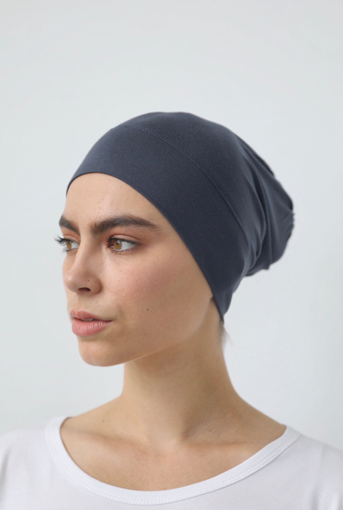Bamboo under-scarf cap designed to cover hair beneath a hijab, made from soft, breathable natural bamboo fibers with cotton spandex stretch for comfort. Partially closed at the back with an elastic edge to comfortably accommodate hair.