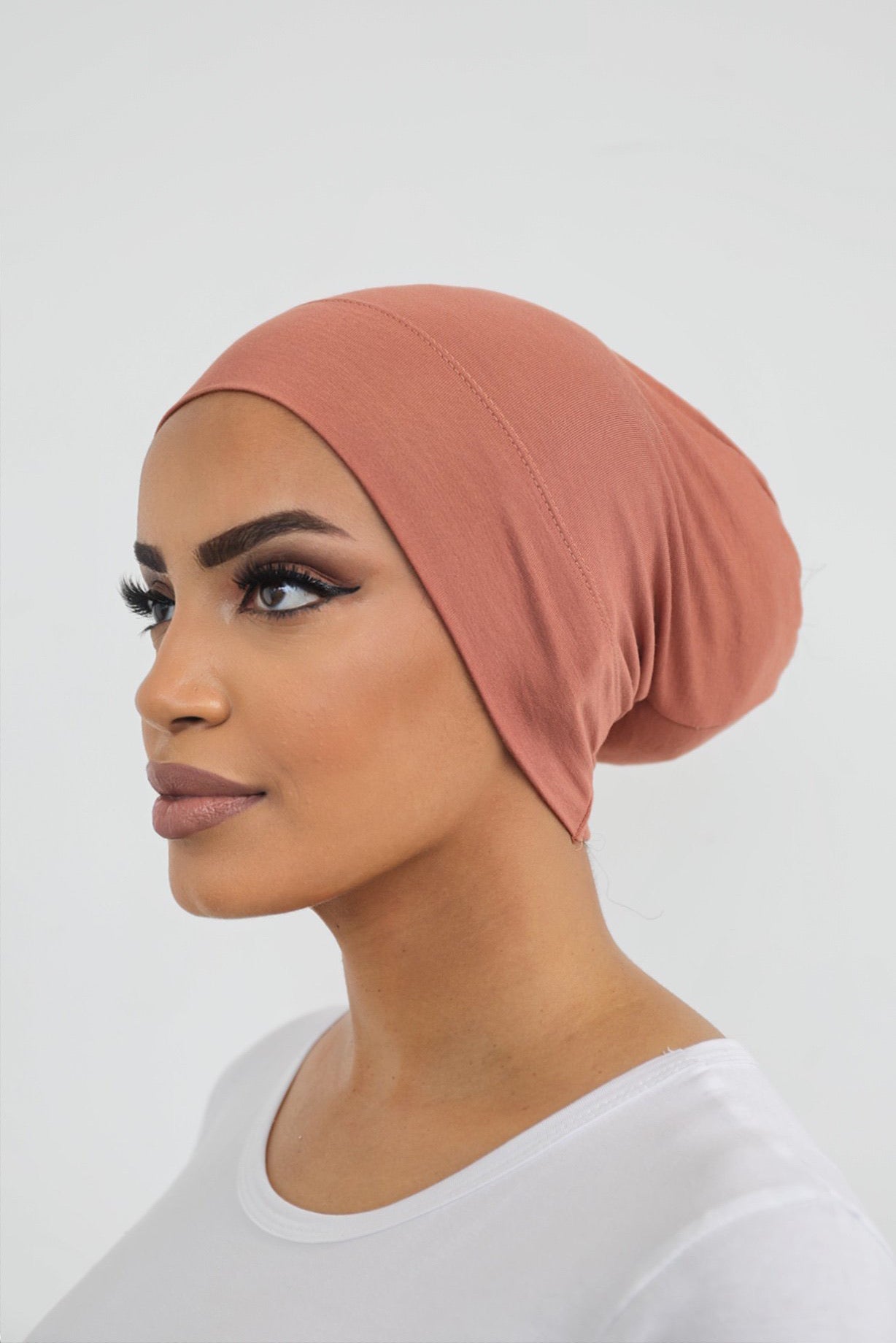 Bamboo under-scarf cap designed to cover hair beneath a hijab, made from soft, breathable natural bamboo fibers with cotton spandex stretch for comfort. Partially closed at the back with an elastic edge to comfortably accommodate hair.