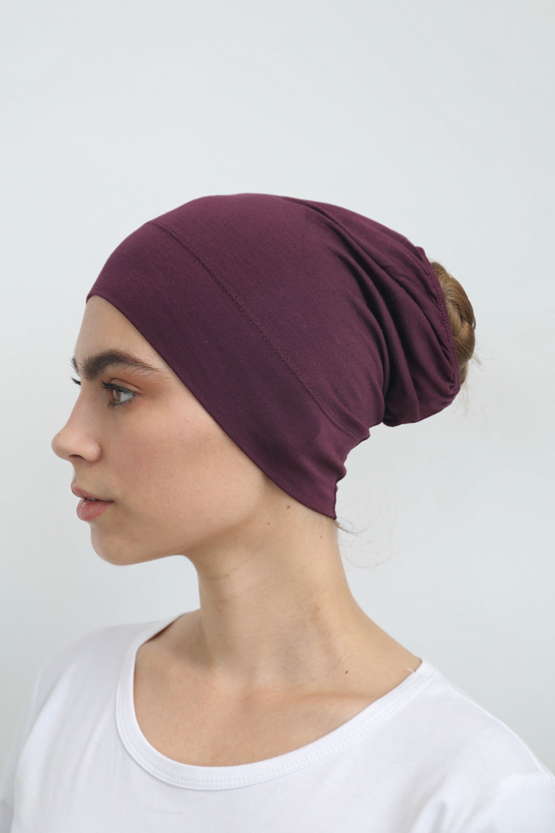 Bamboo under-scarf cap designed to cover hair beneath a hijab, made from soft, breathable natural bamboo fibers with cotton spandex stretch for comfort. Partially closed at the back with an elastic edge to comfortably accommodate hair.