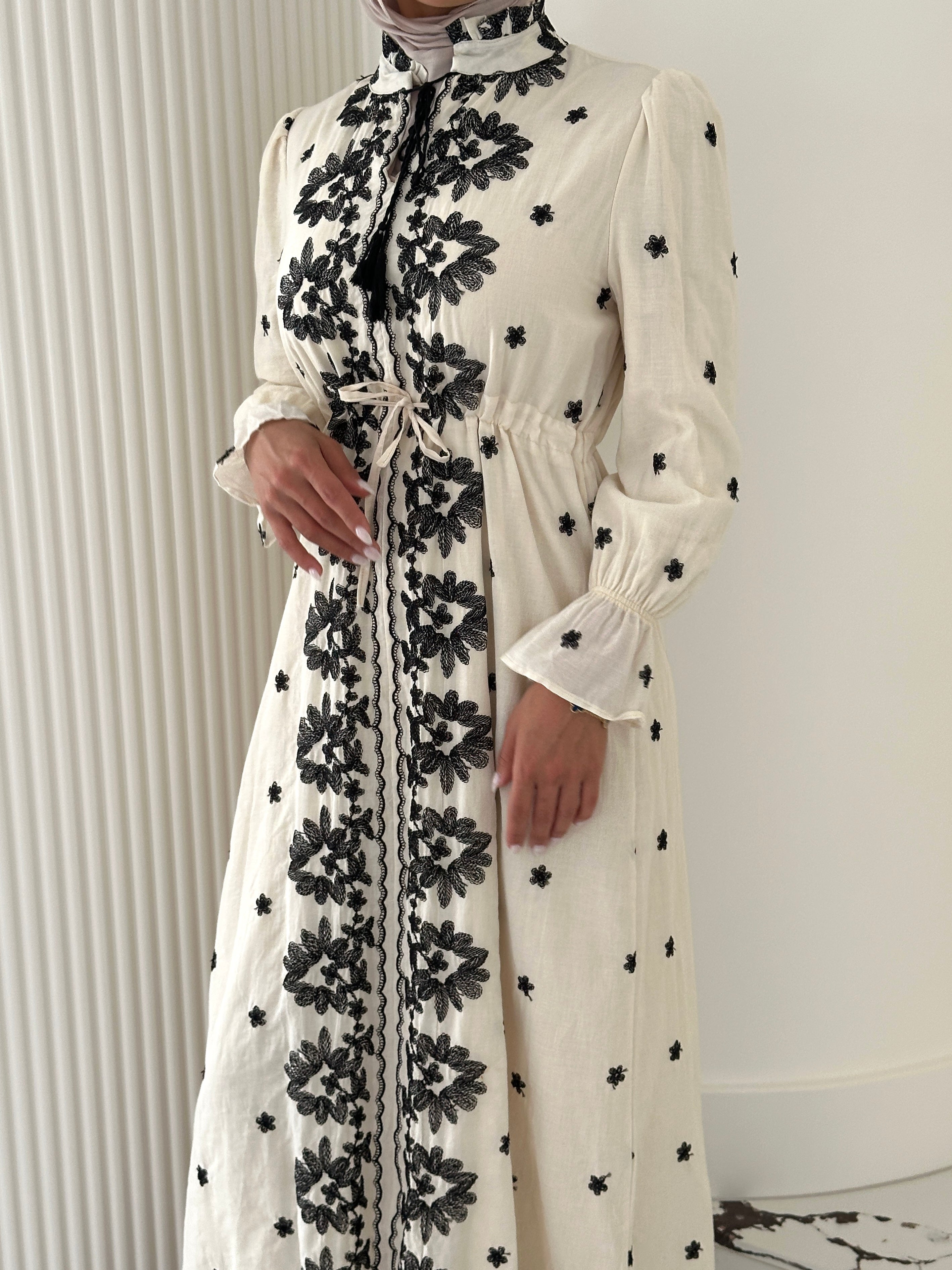 women's modest maxi dress in black and ivory with floral embroidery. dress is lined, long sleeve and lightweight, hijabi friendly and feminine for brunch, party, dinner, events and eid. 