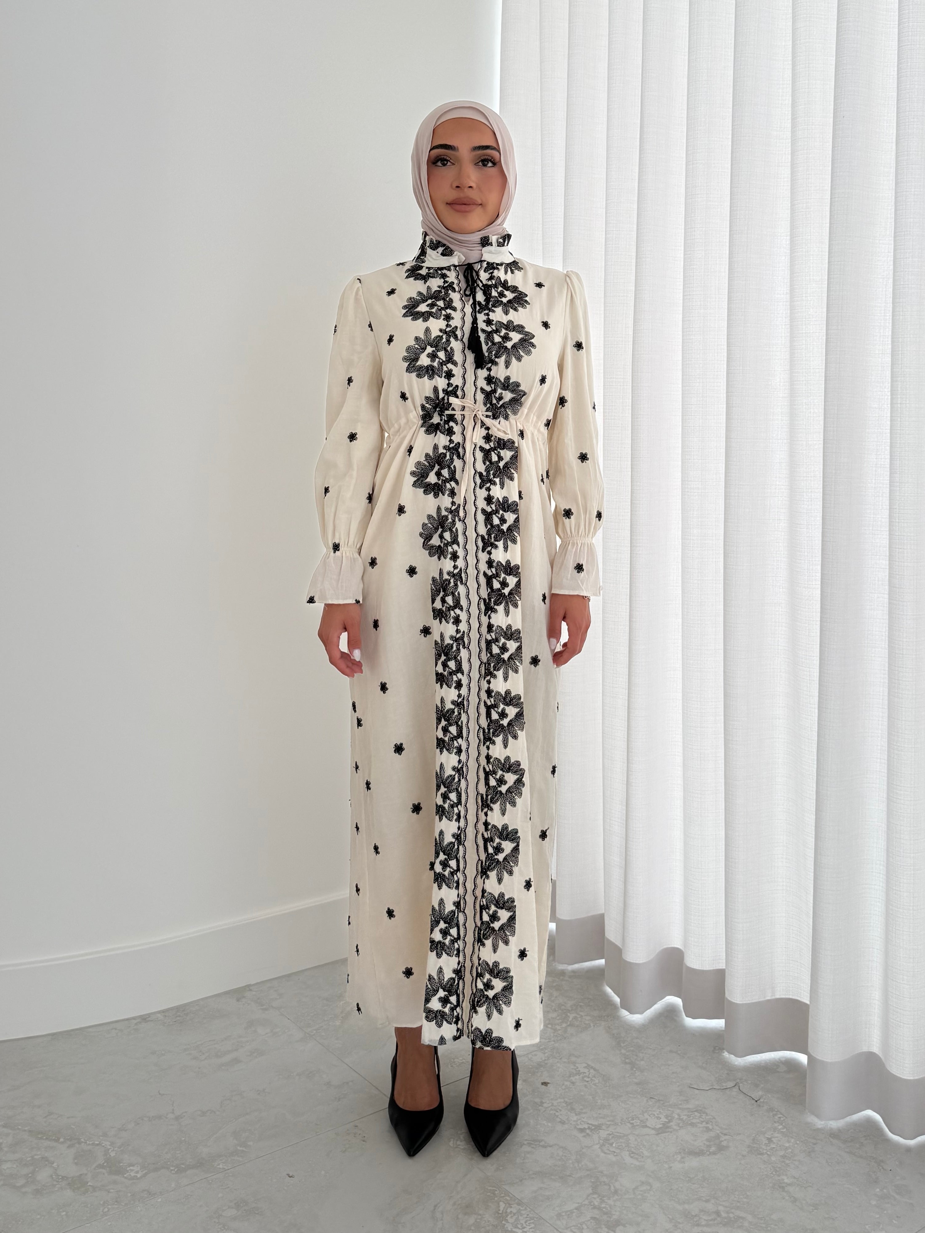 women's modest maxi dress in black and ivory with floral embroidery. dress is lined, long sleeve and lightweight, hijabi friendly and feminine for brunch, party, dinner, events and eid. 