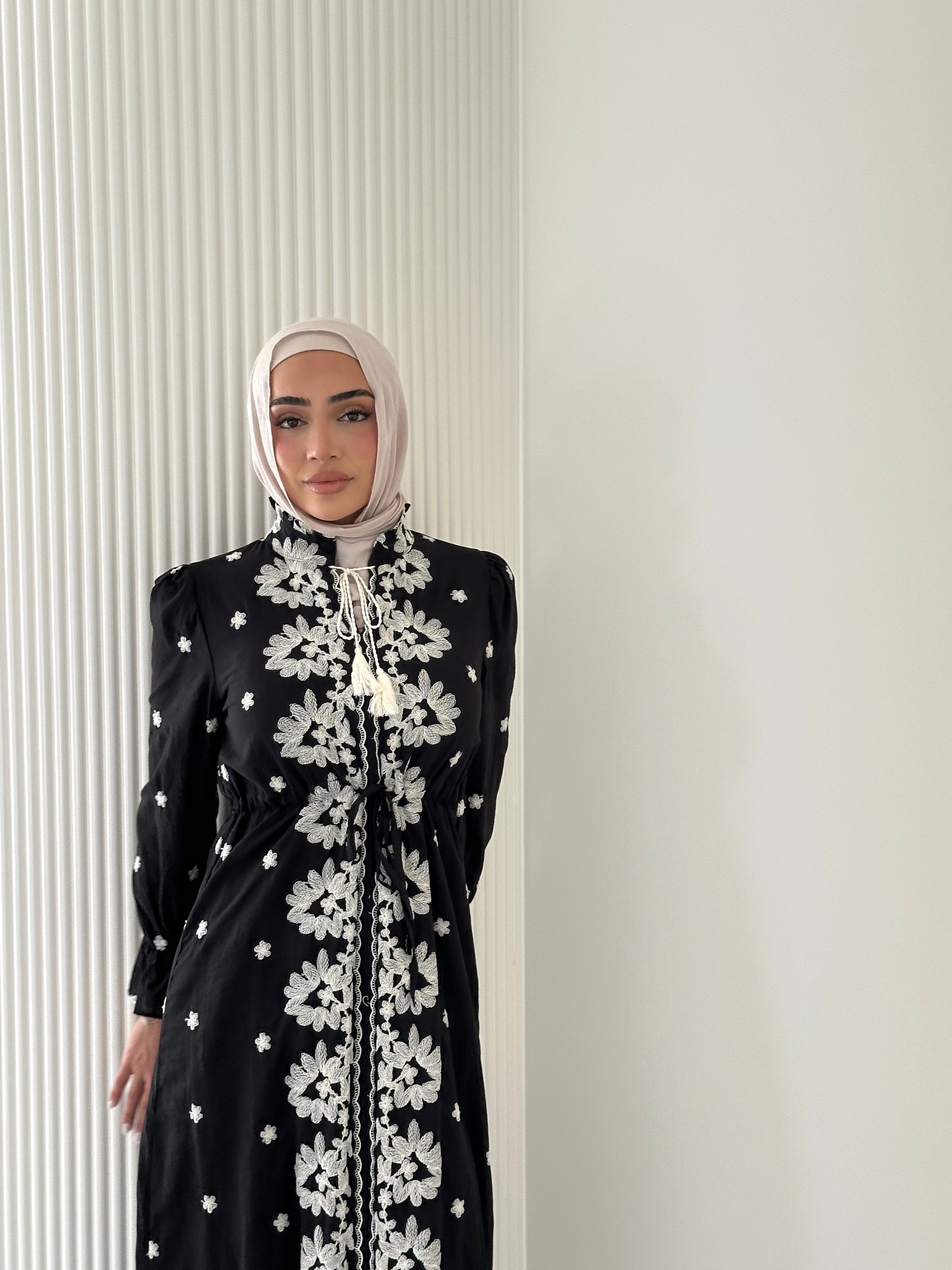 women's modest maxi dress in black and ivory with floral embroidery. dress is lined, long sleeve and lightweight, hijabi friendly and feminine for brunch, party, dinner, events and eid. 