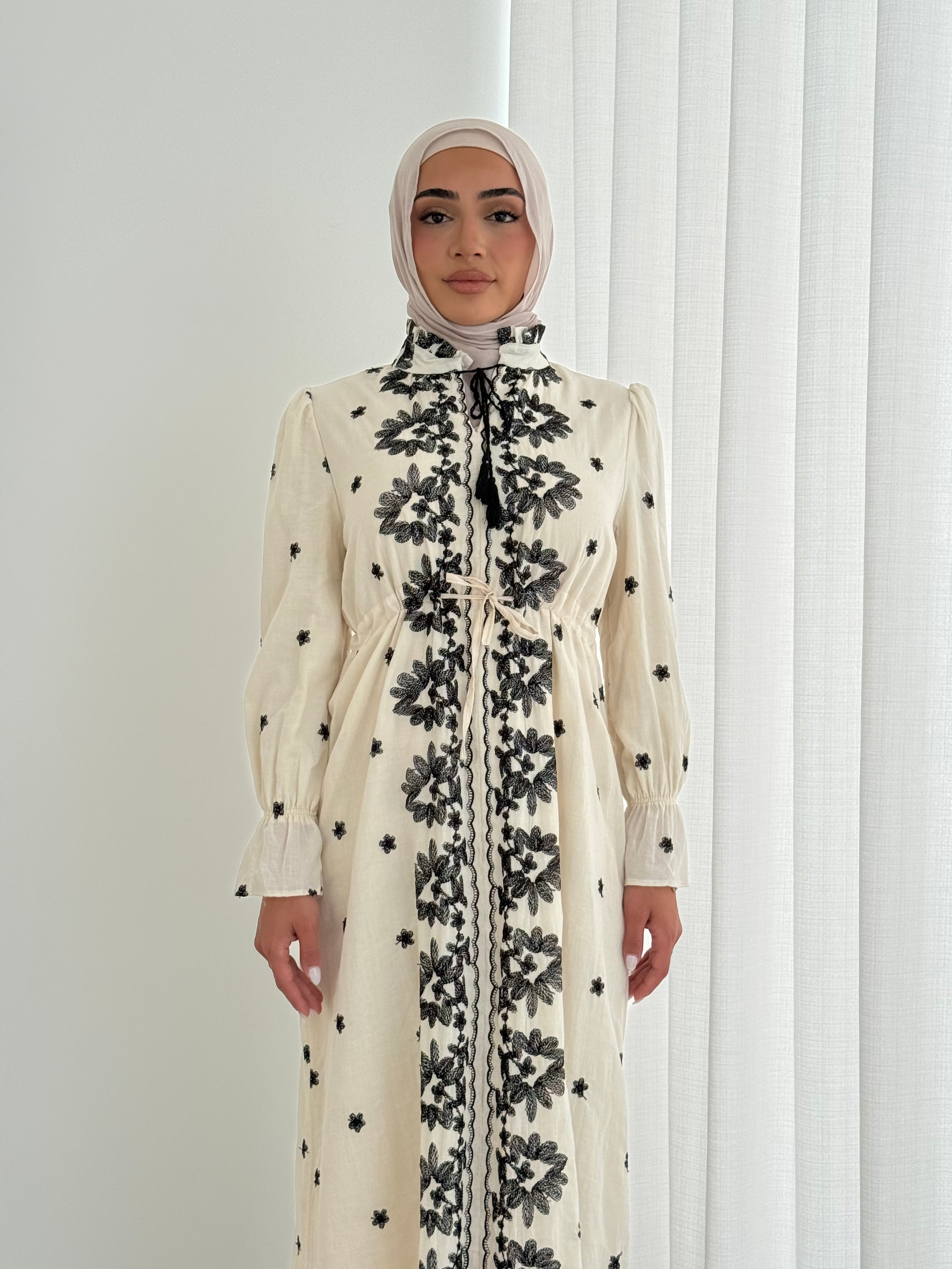 women's modest maxi dress in black and ivory with floral embroidery. dress is lined, long sleeve and lightweight, hijabi friendly and feminine for brunch, party, dinner, events and eid. 