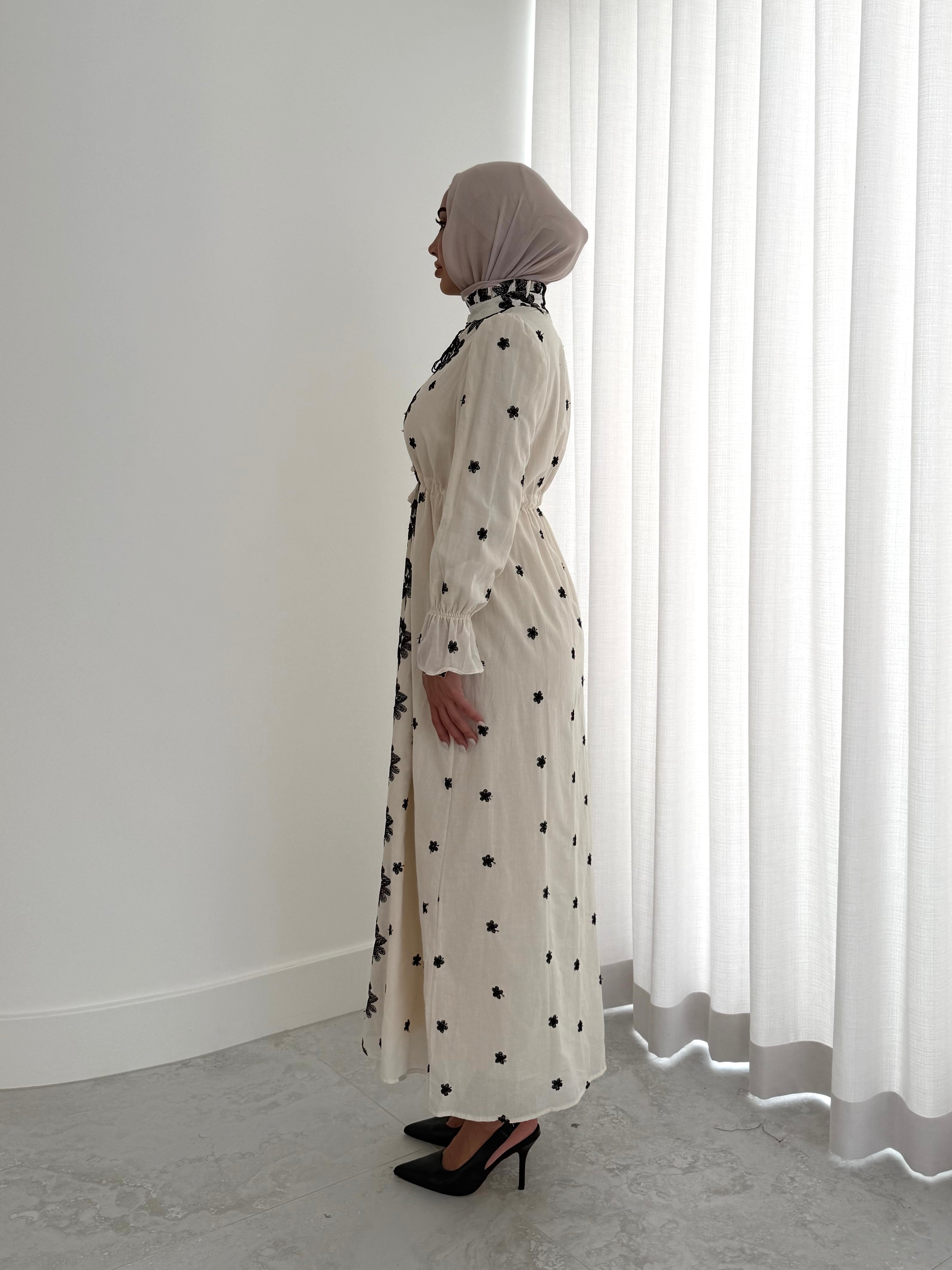 women's modest maxi dress in black and ivory with floral embroidery. dress is lined, long sleeve and lightweight, hijabi friendly and feminine for brunch, party, dinner, events and eid. 