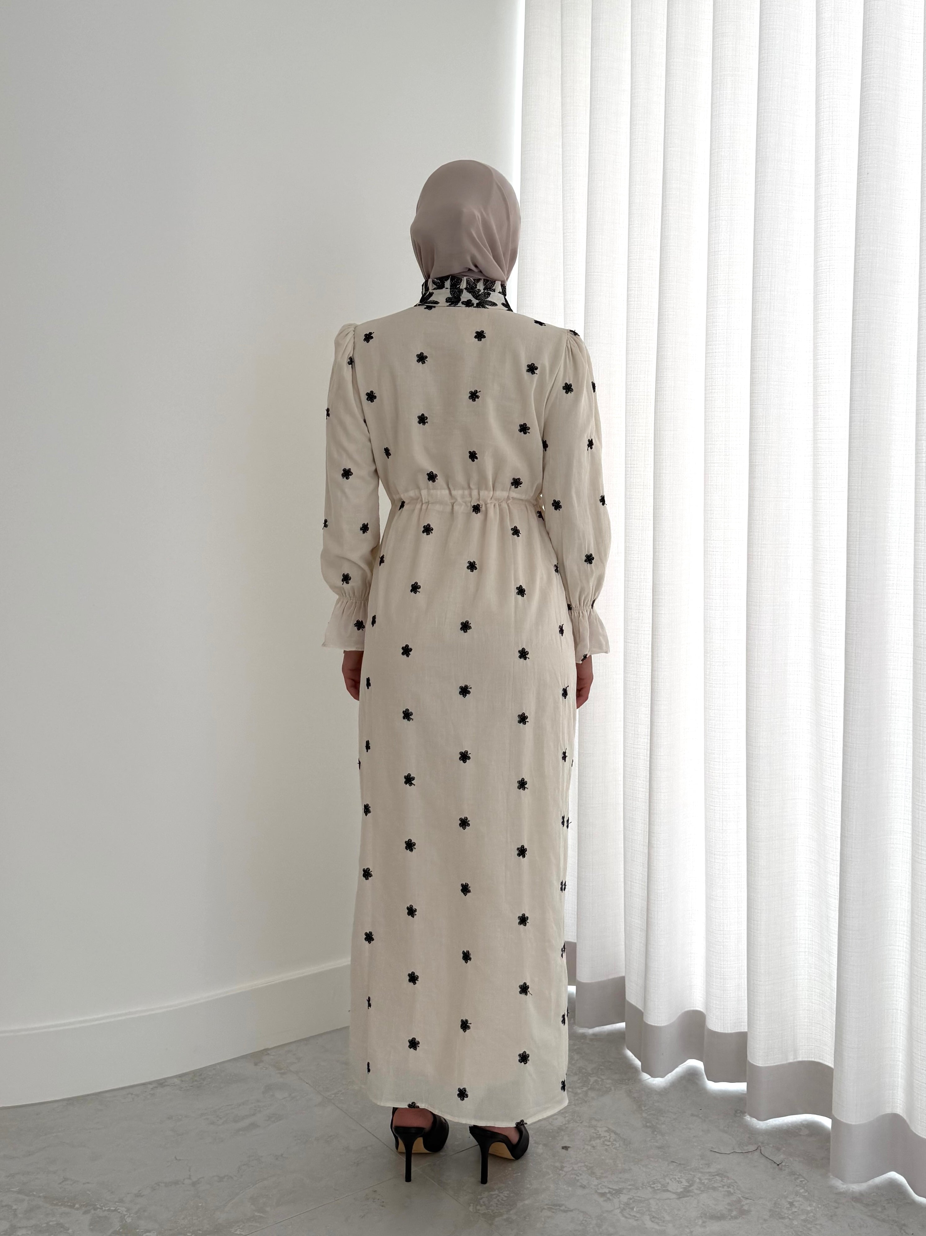 women's modest maxi dress in black and ivory with floral embroidery. dress is lined, long sleeve and lightweight, hijabi friendly and feminine for brunch, party, dinner, events and eid. 