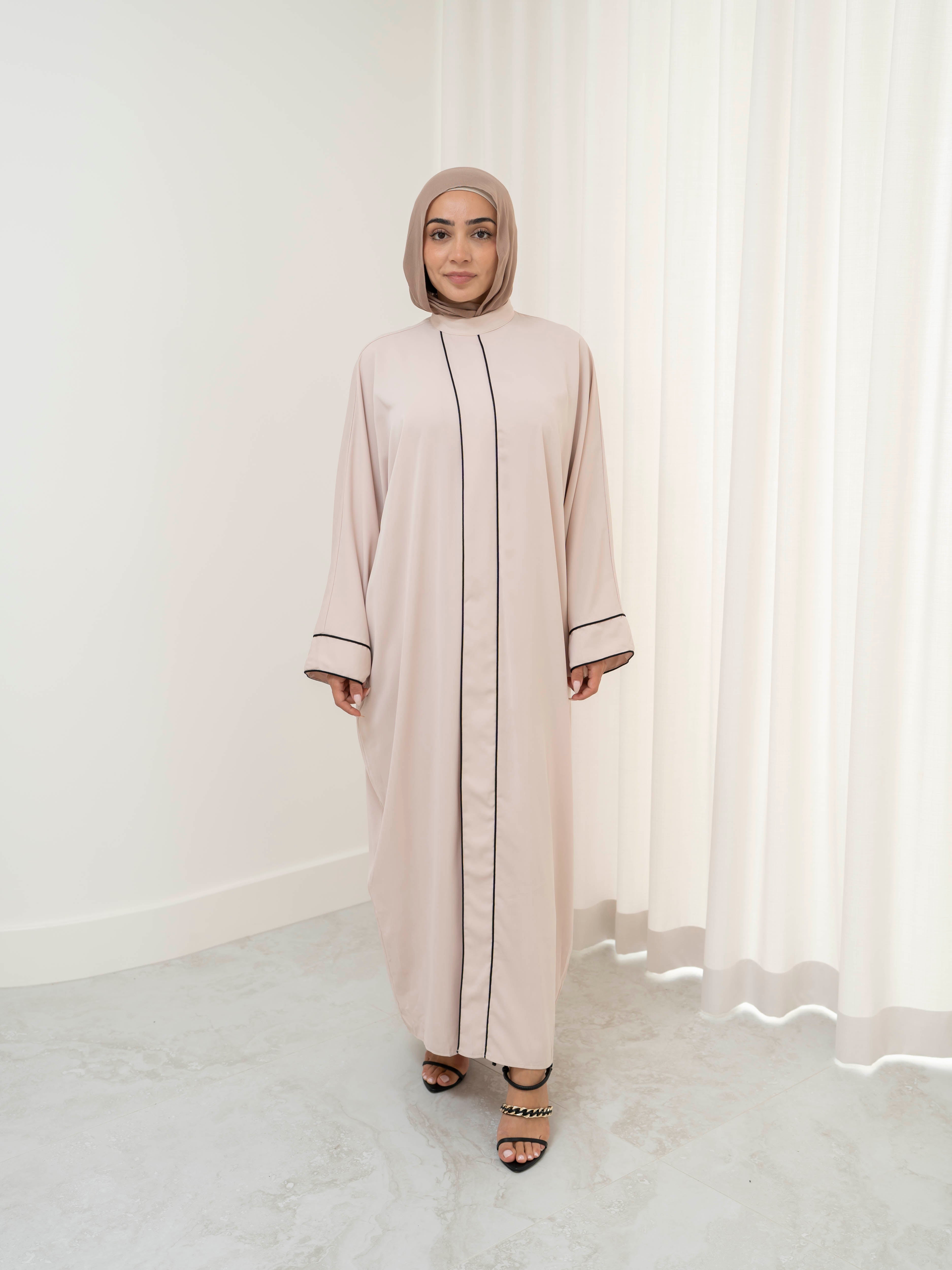 Model wearing the Noor Line abaya featuring a clean silhouette with subtle line detailing, styled for a modest and elegant look suitable for Ramadan and Eid.