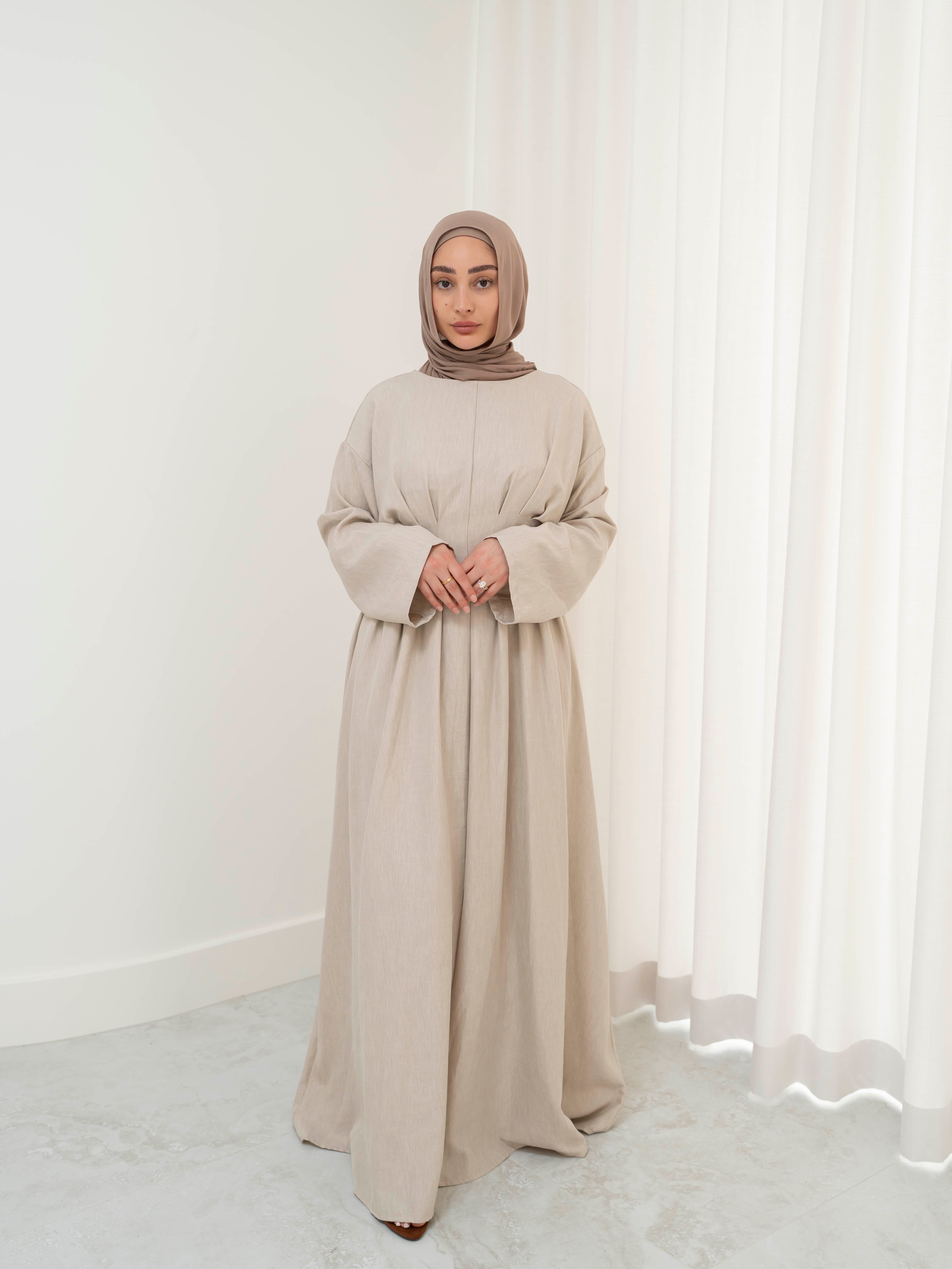 Model wearing the Safa pleated dress featuring a flowing silhouette with soft pleat detailing, styled for a modest and elegant look suitable for Ramadan and Eid.