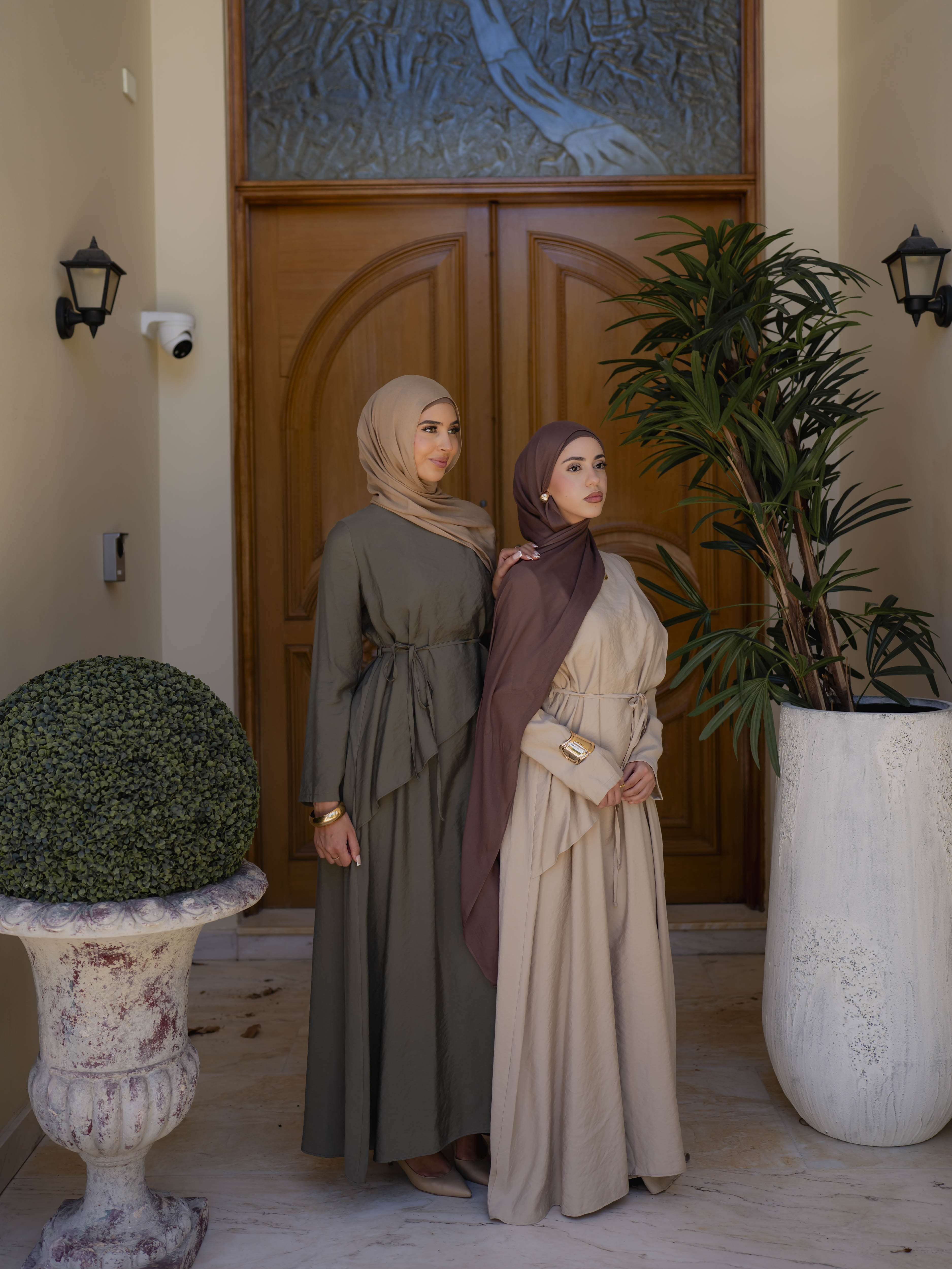 Model wearing the Kareema A-line tie waist dress featuring a flowing silhouette and waist tie detail, styled for a modest and elegant look suitable for Ramadan and Eid.