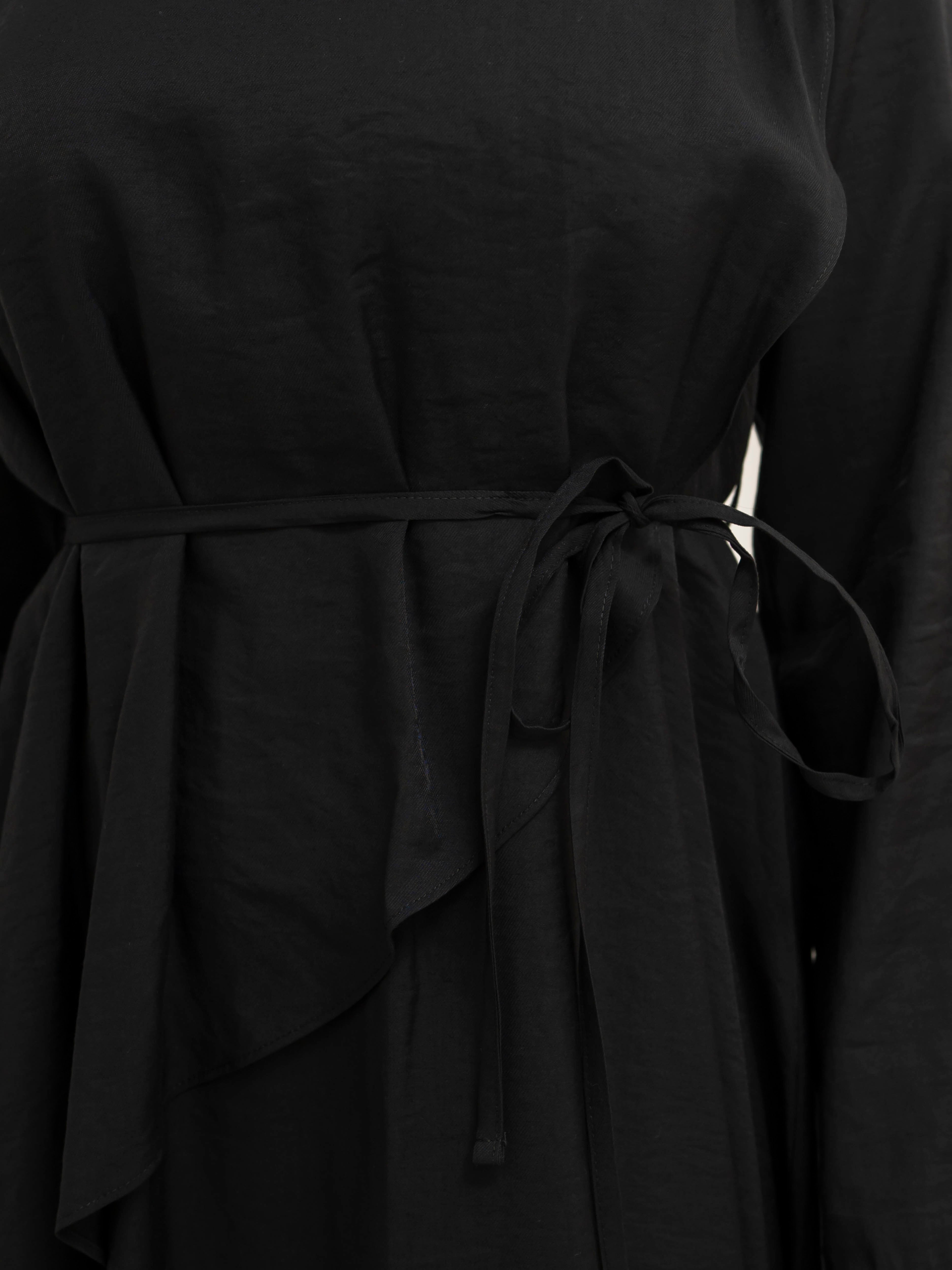 Model wearing the Kareema A-line tie waist dress featuring a flowing silhouette and waist tie detail, styled for a modest and elegant look suitable for Ramadan and Eid.