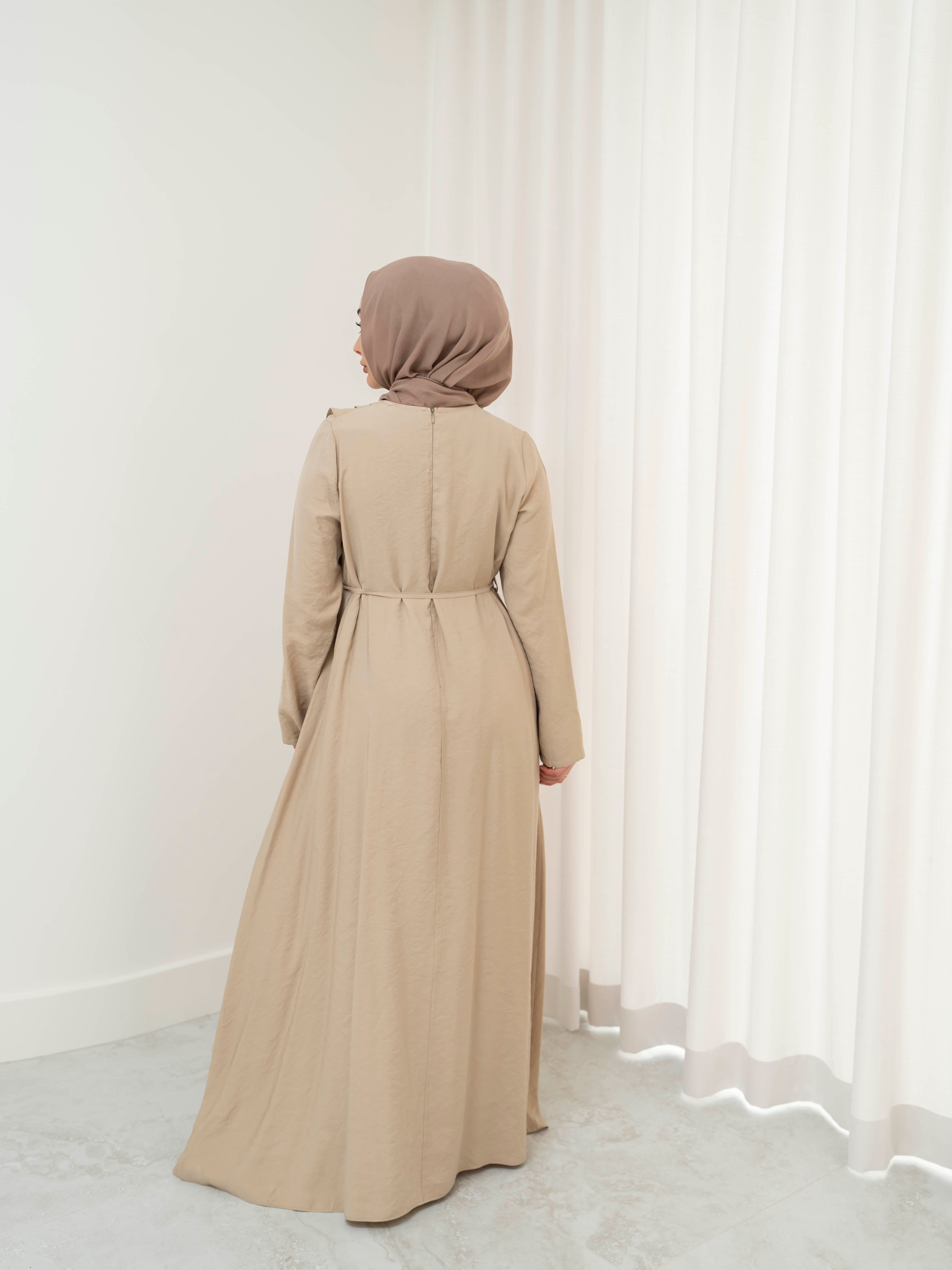 Model wearing the Kareema A-line tie waist dress featuring a flowing silhouette and waist tie detail, styled for a modest and elegant look suitable for Ramadan and Eid.
