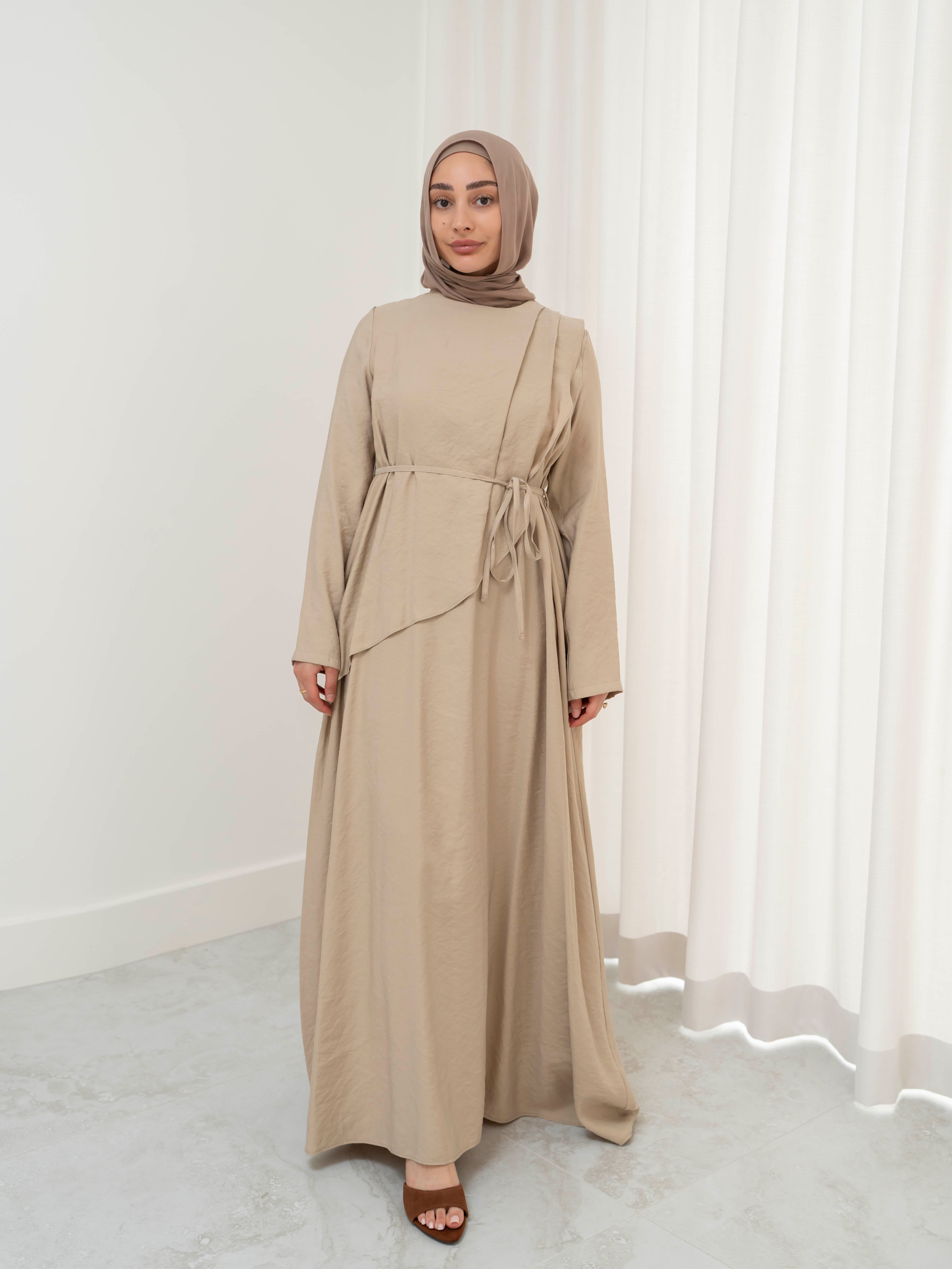 Model wearing the Kareema A-line tie waist dress featuring a flowing silhouette and waist tie detail, styled for a modest and elegant look suitable for Ramadan and Eid.