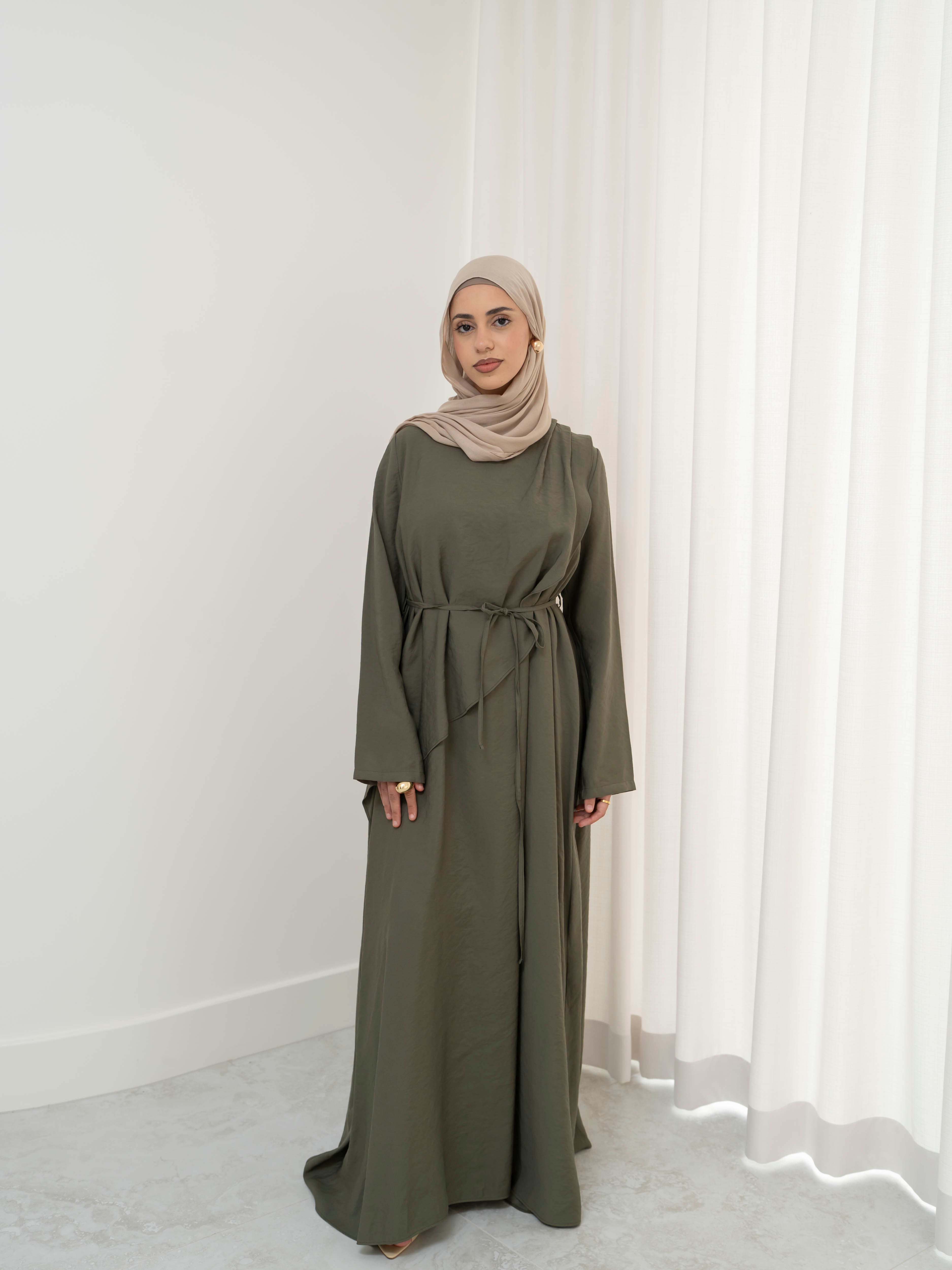 Model wearing the Kareema A-line tie waist dress featuring a flowing silhouette and waist tie detail, styled for a modest and elegant look suitable for Ramadan and Eid.