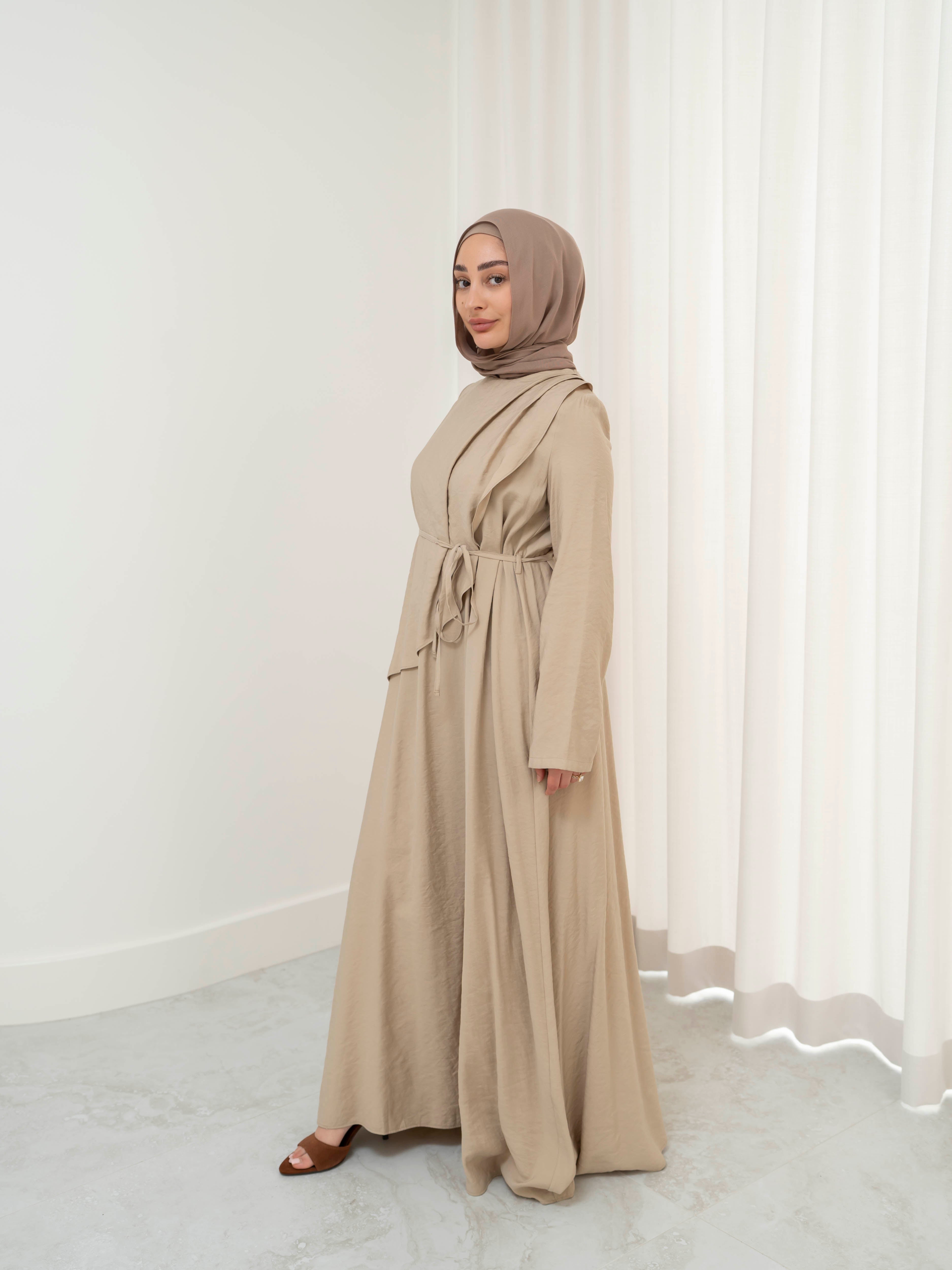 Model wearing the Kareema A-line tie waist dress featuring a flowing silhouette and waist tie detail, styled for a modest and elegant look suitable for Ramadan and Eid.