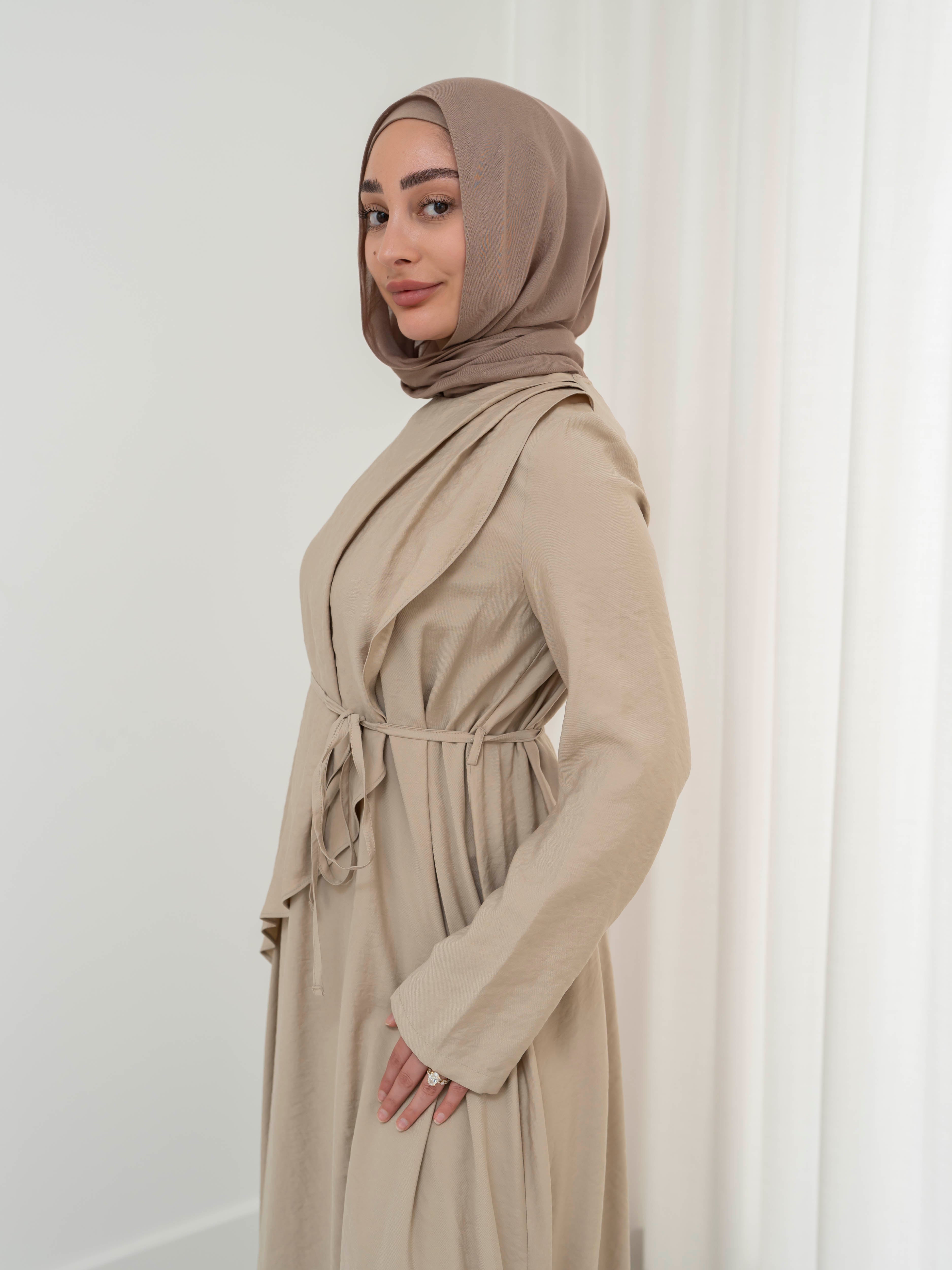 Model wearing the Kareema A-line tie waist dress featuring a flowing silhouette and waist tie detail, styled for a modest and elegant look suitable for Ramadan and Eid.