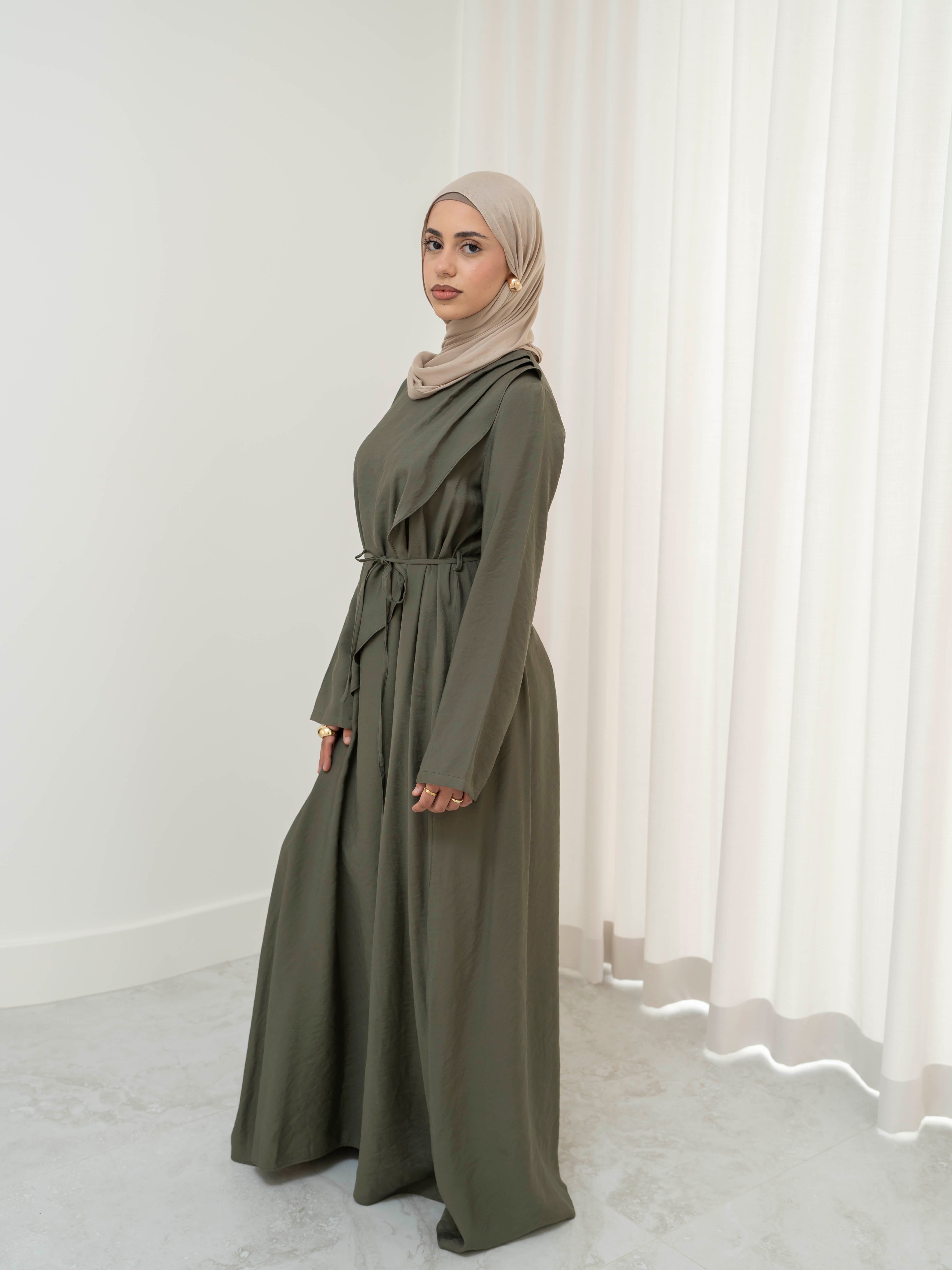 Model wearing the Kareema A-line tie waist dress featuring a flowing silhouette and waist tie detail, styled for a modest and elegant look suitable for Ramadan and Eid.