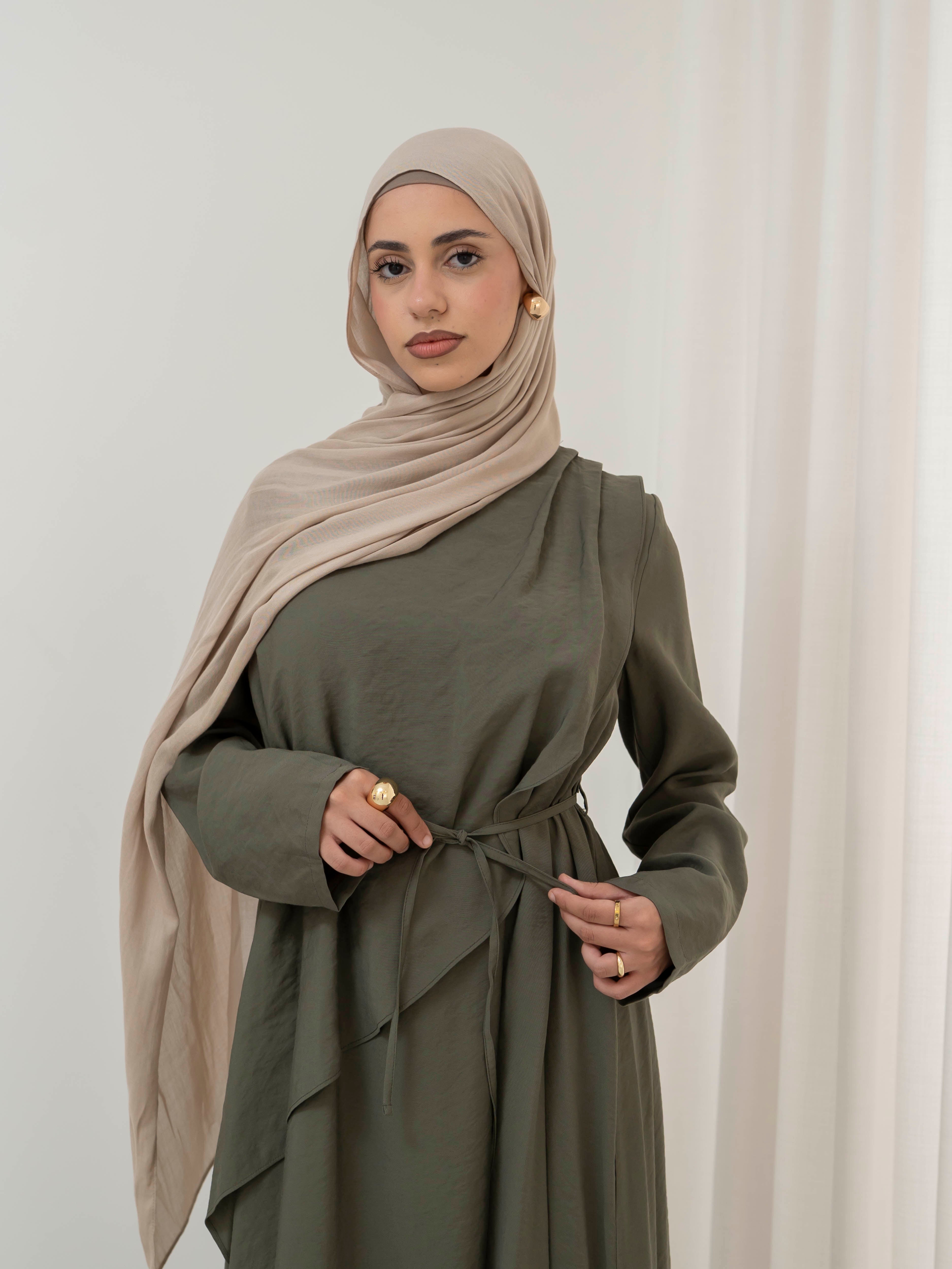 Model wearing the Kareema A-line tie waist dress featuring a flowing silhouette and waist tie detail, styled for a modest and elegant look suitable for Ramadan and Eid.