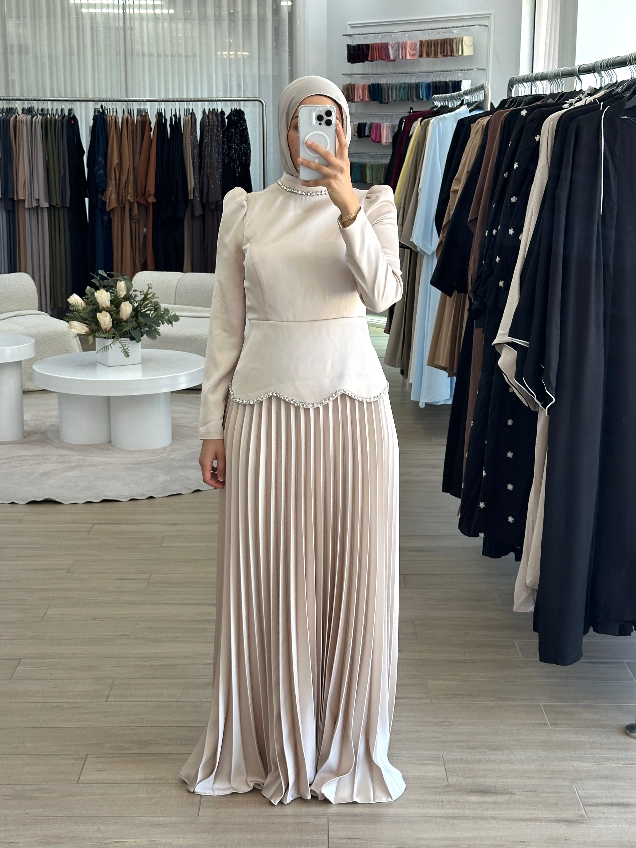 women's maxi full length formal dress with satin bodice and minimal jewel embellishment and satin pleated skirt. Dress is long sleeve, with full coverage and is modest for hijabi fashion. suitable to wear for engagement, wedding, party, formals etc.