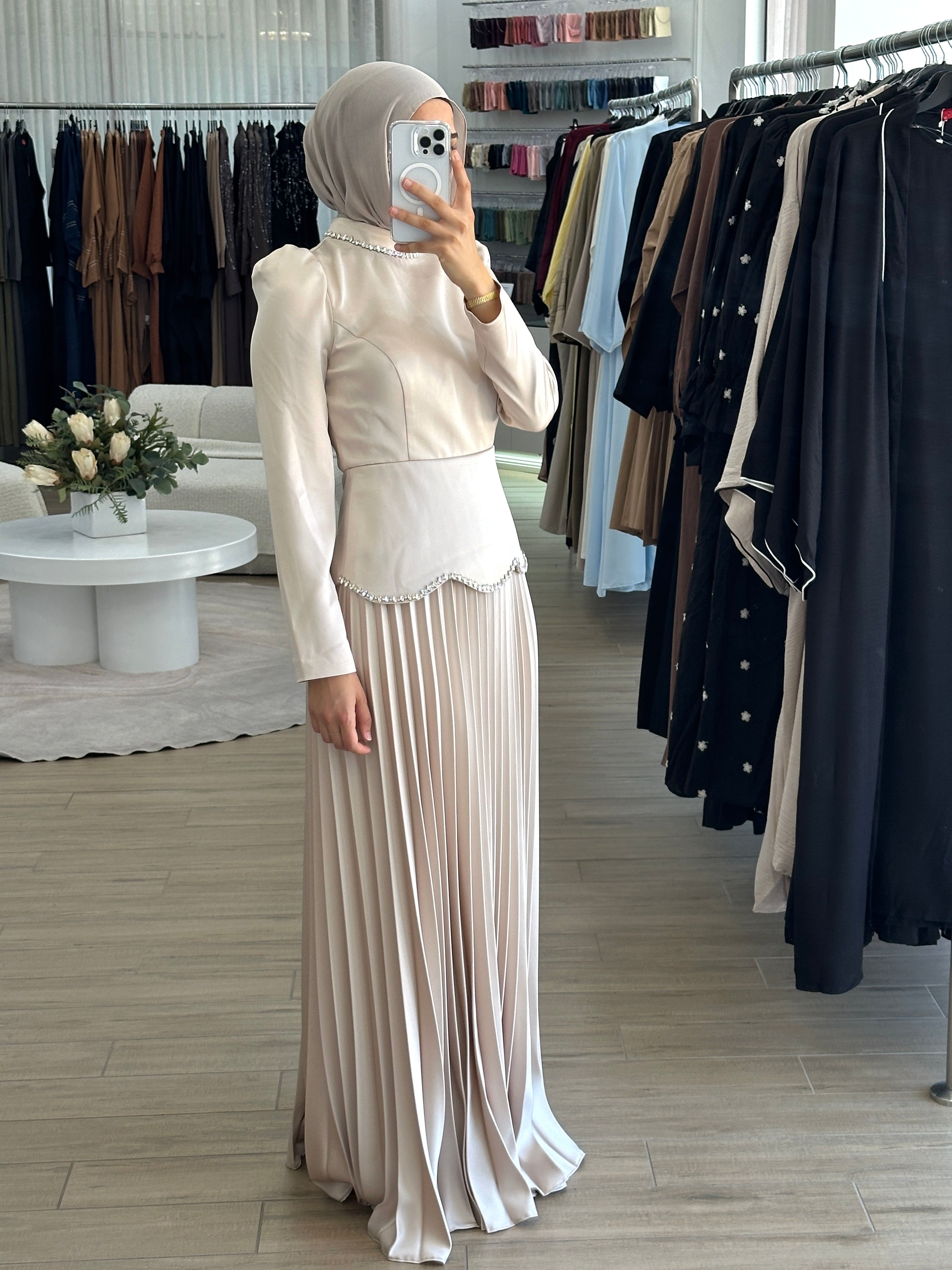 women's maxi full length formal dress with satin bodice and minimal jewel embellishment and satin pleated skirt. Dress is long sleeve, with full coverage and is modest for hijabi fashion. suitable to wear for engagement, wedding, party, formals etc.