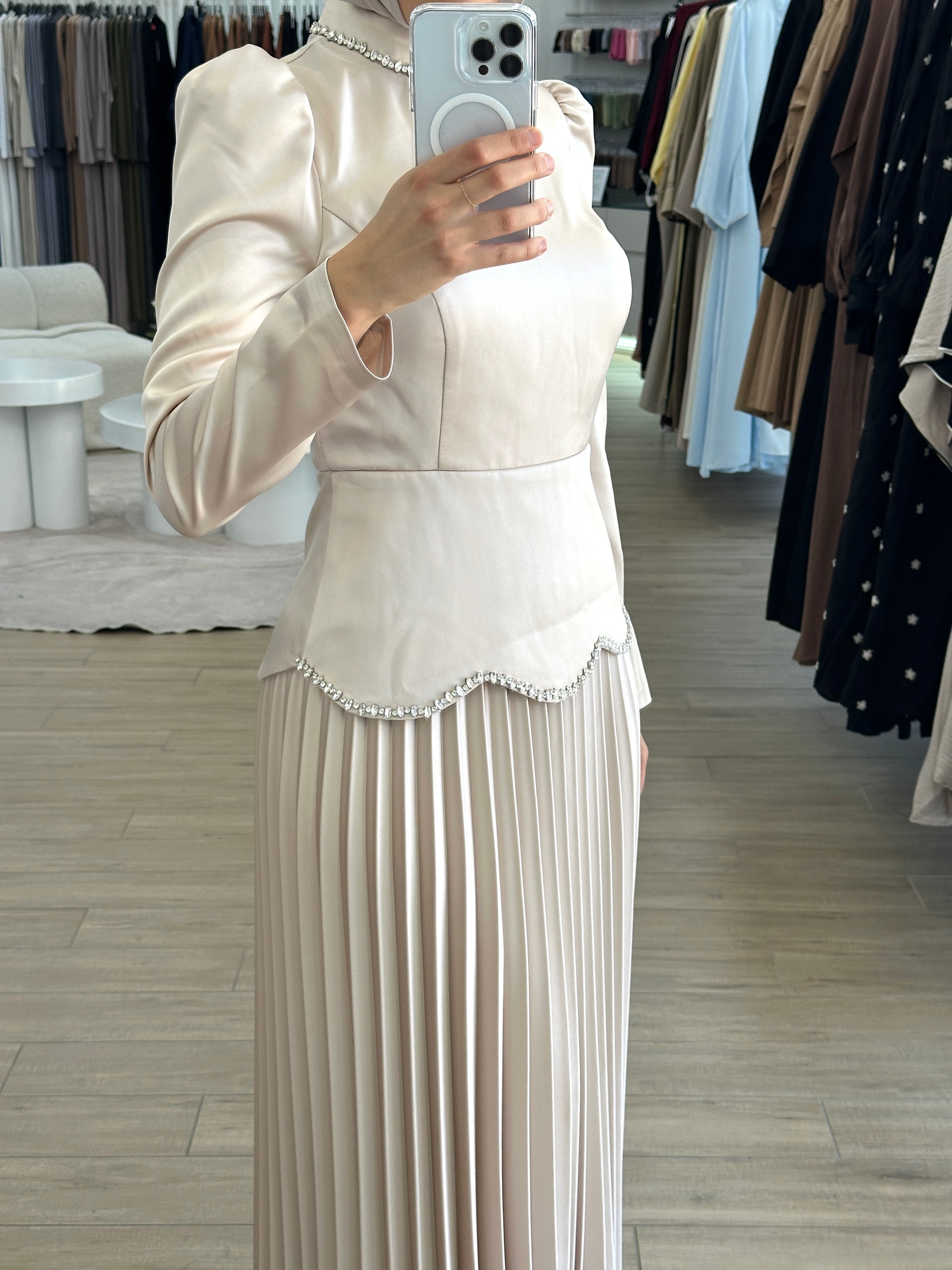 women's maxi full length formal dress with satin bodice and minimal jewel embellishment and satin pleated skirt. Dress is long sleeve, with full coverage and is modest for hijabi fashion. suitable to wear for engagement, wedding, party, formals etc.