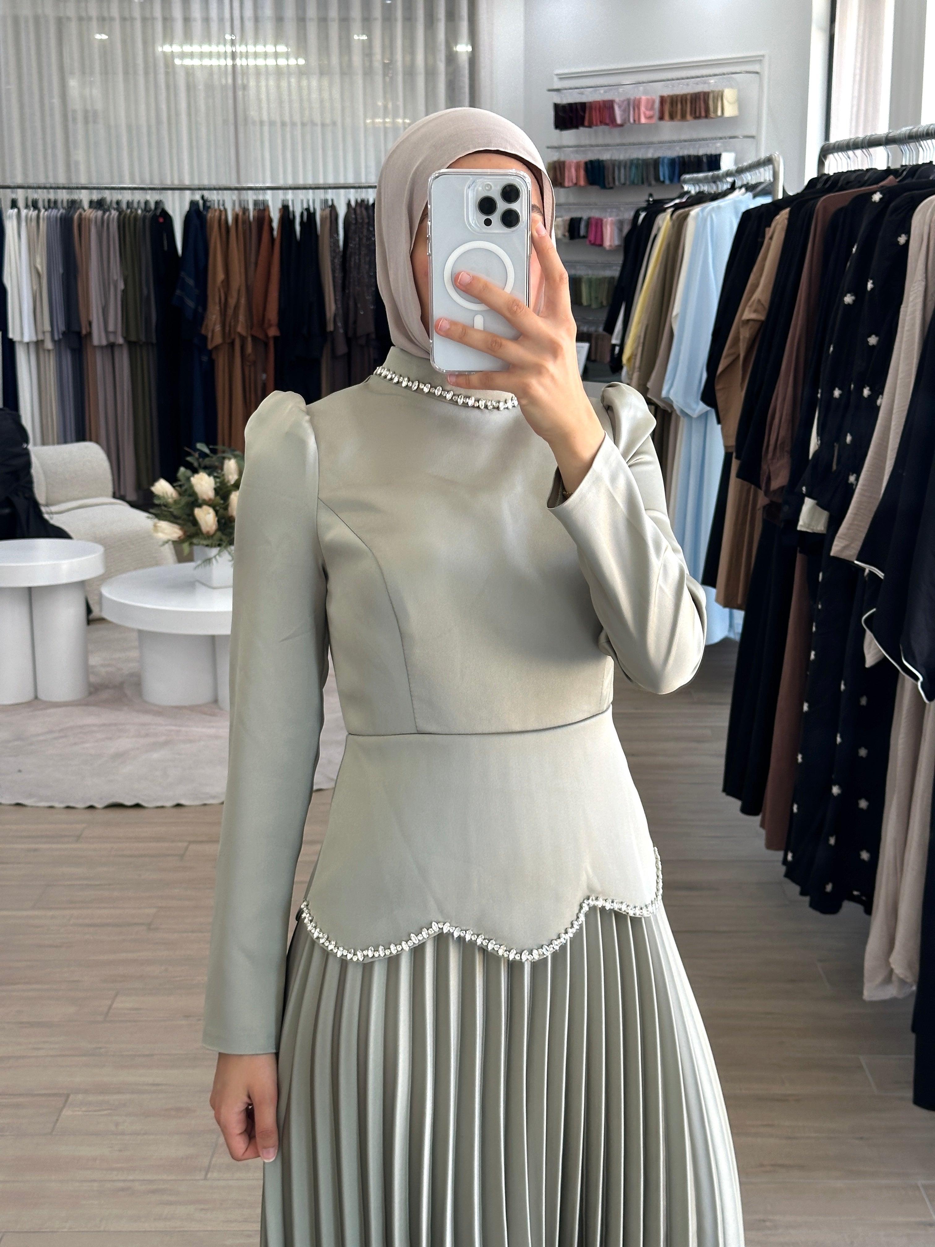 women's maxi full length formal dress with satin bodice and minimal jewel embellishment and satin pleated skirt. Dress is long sleeve, with full coverage and is modest for hijabi fashion. suitable to wear for engagement, wedding, party, formals etc.