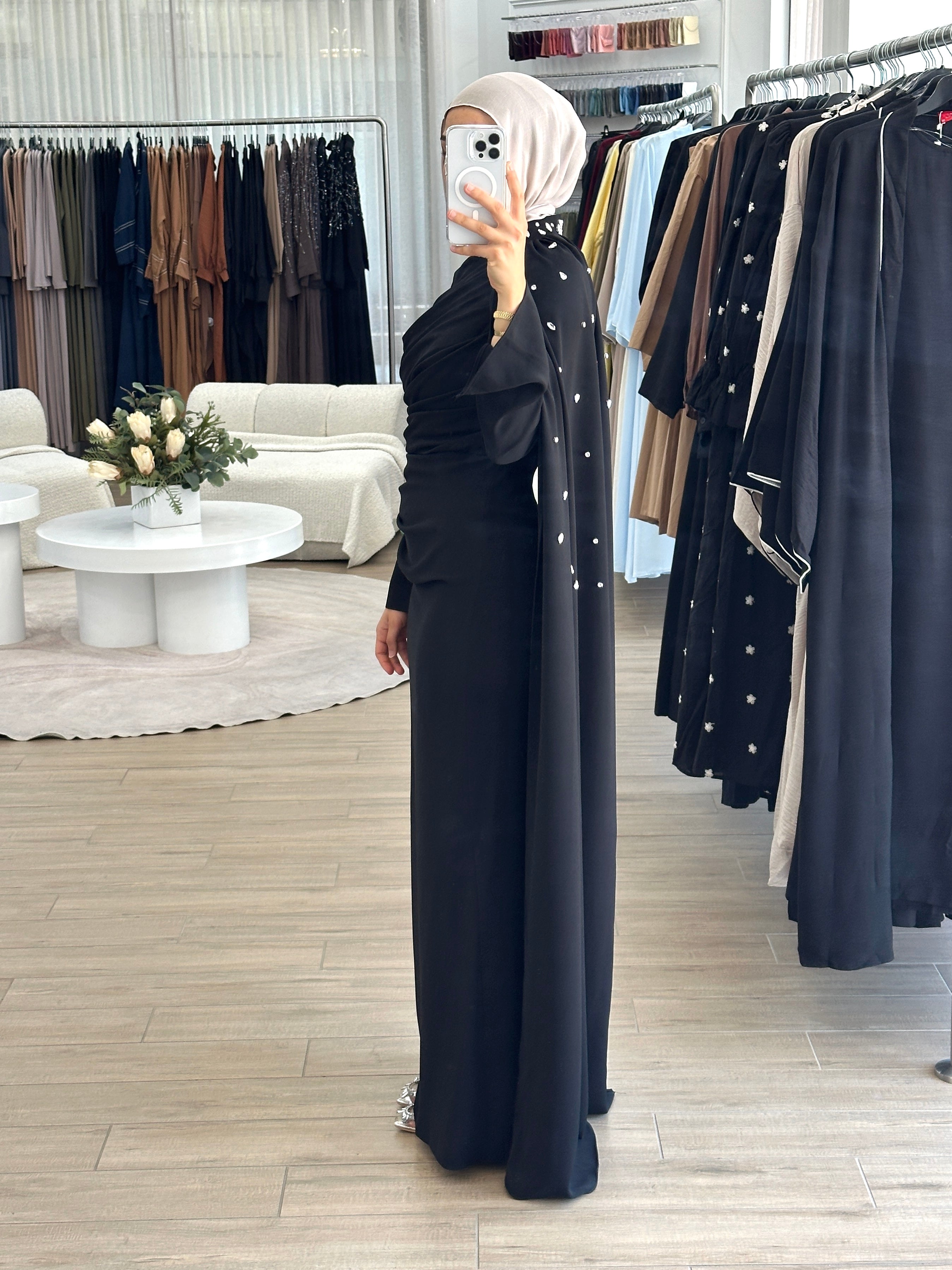 women's full length maxi formal dress in black with minimal jewel embellishment. Dress is fitted on the waist with ruching and a cape that drapes off the shoulders. elegant to wear to any event/ occasion, suitable for hijabis.