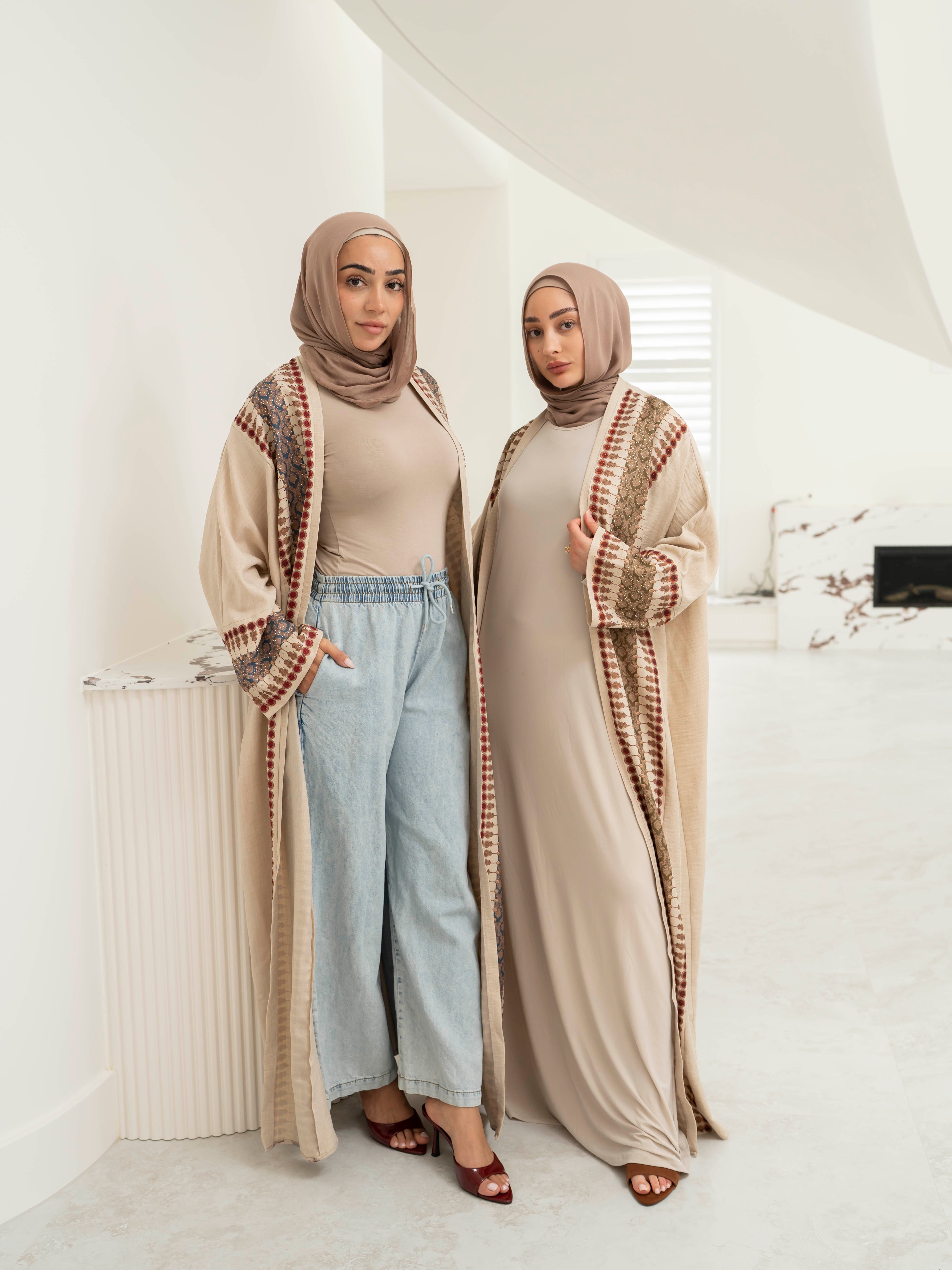 Model wearing the Andalus open abaya with an intricate patterned fabric and subtle embellishments, styled open for a modest and elegant look suitable for Ramadan and Eid.