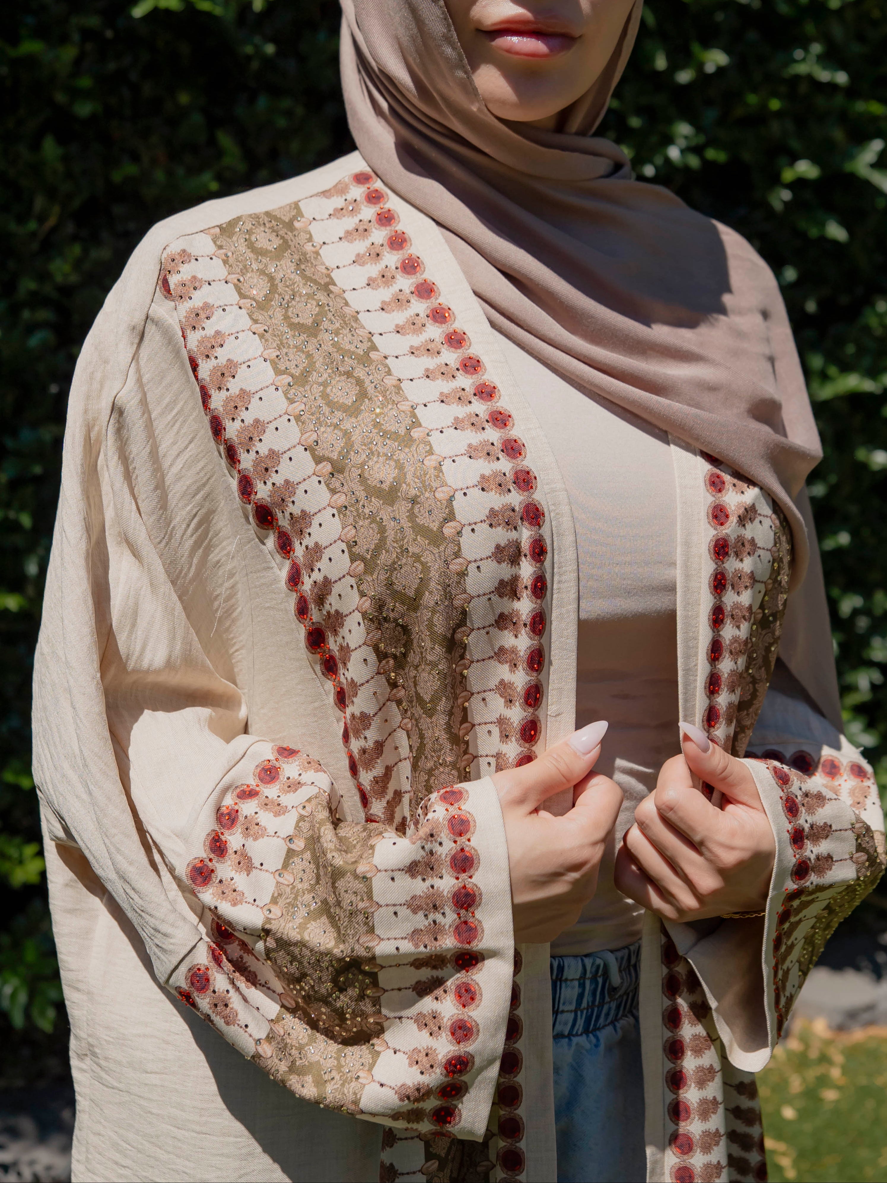 Model wearing the Andalus open abaya with an intricate patterned fabric and subtle embellishments, styled open for a modest and elegant look suitable for Ramadan and Eid.